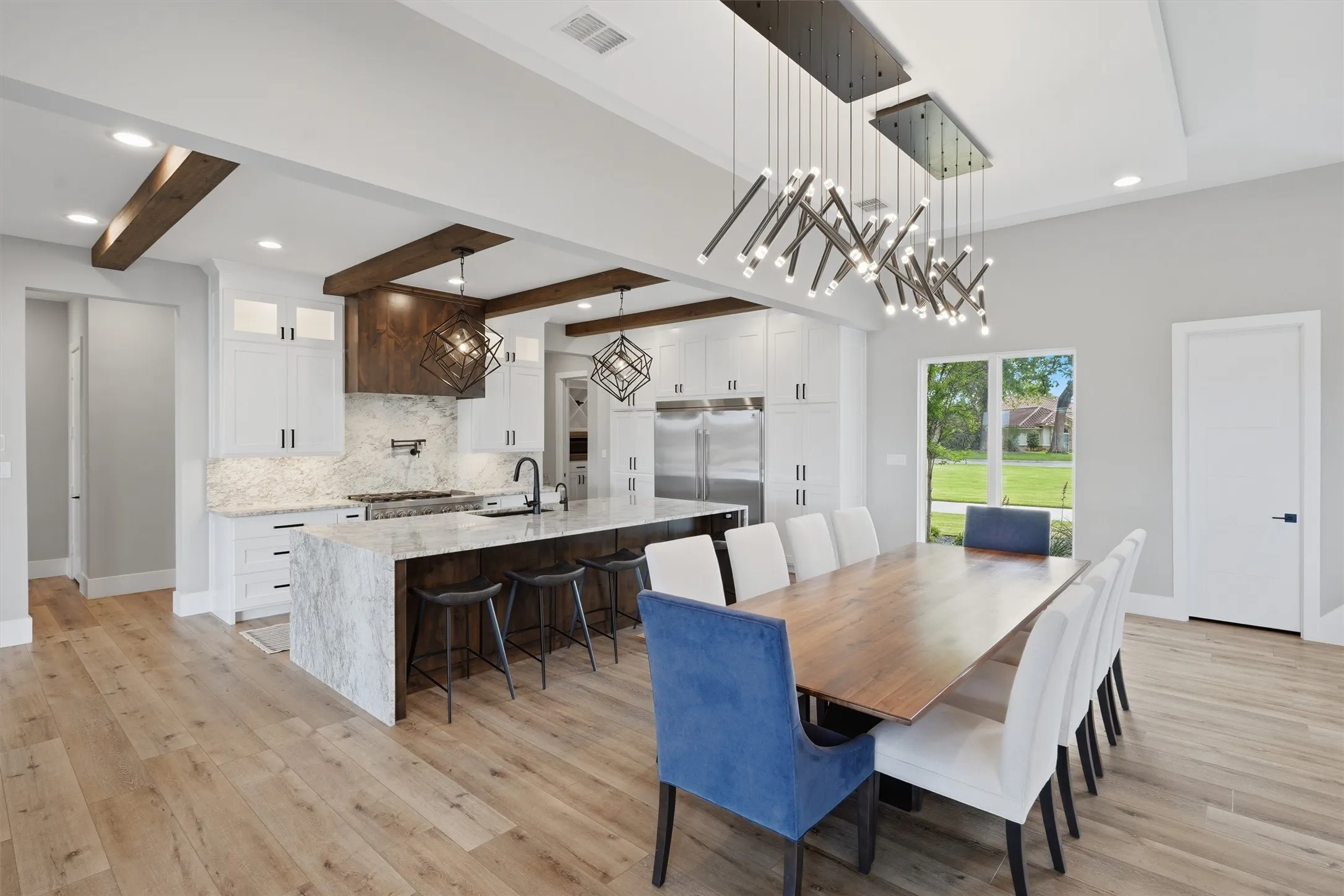 Dining room featuring recessed lighting, beamed ceiling, and light wood-style flooring