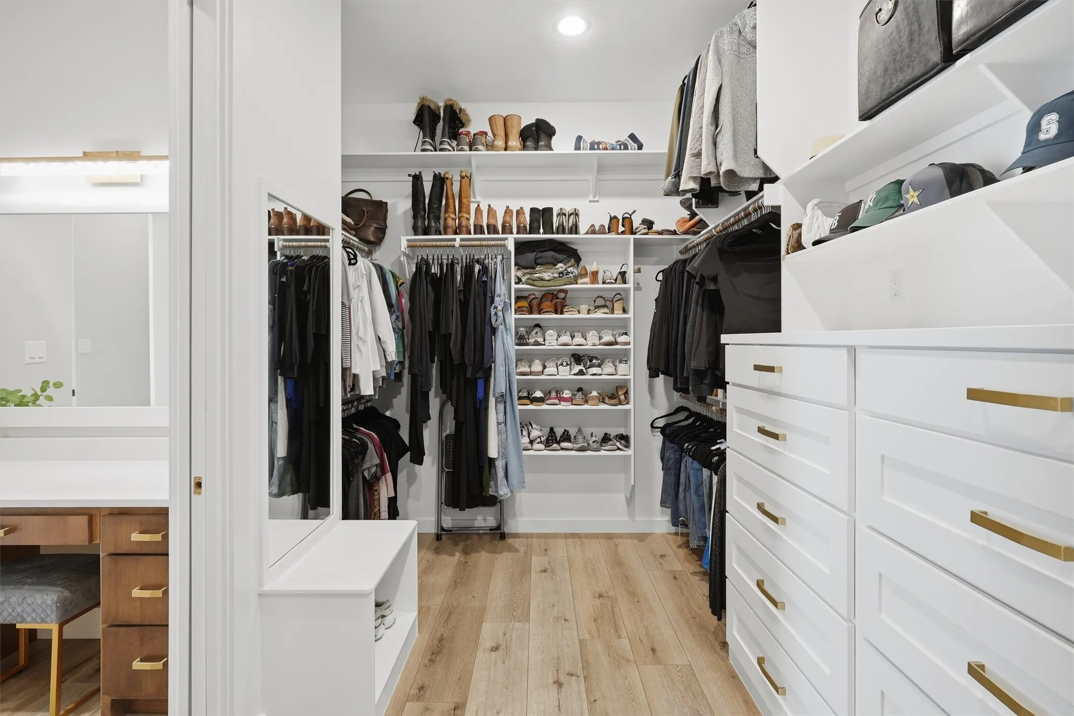 Walk in closet featuring built in dresser drawers and storage