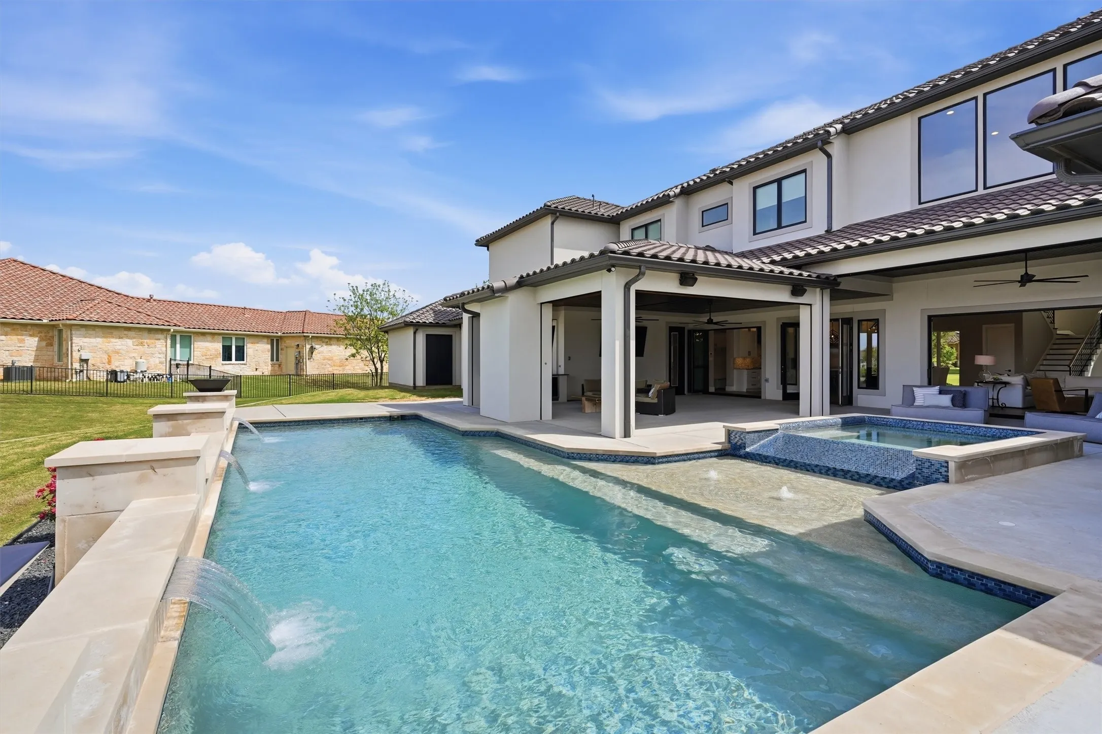 Back of property featuring a patio, stucco siding, a ceiling fan, and a tile roof