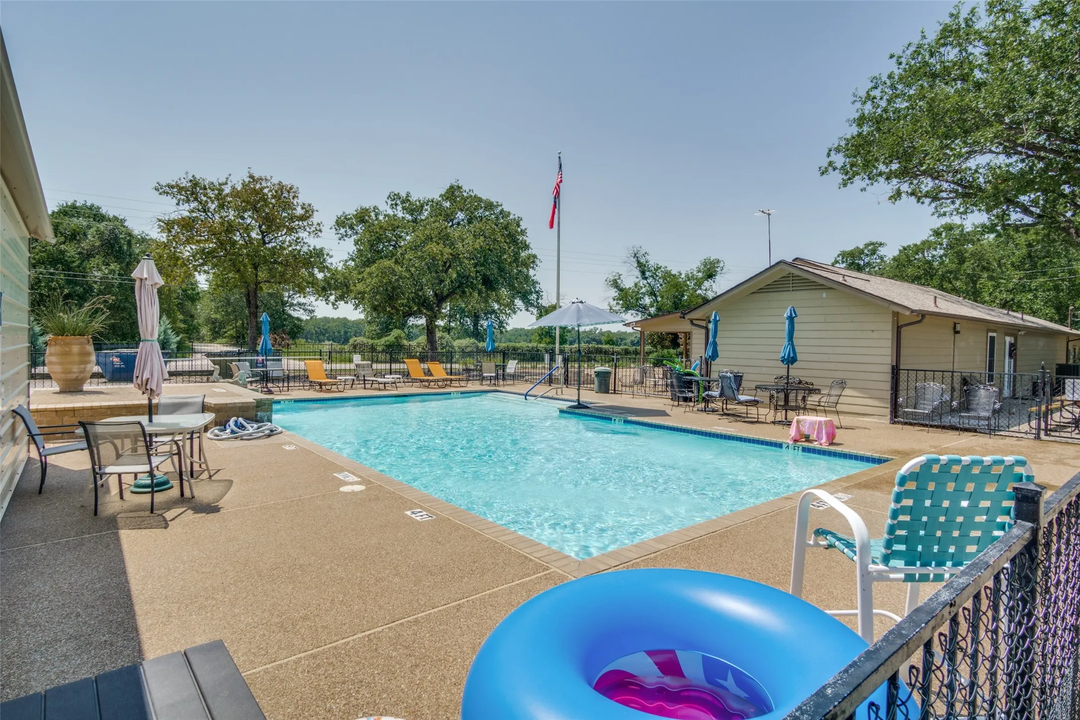 Community pool with a patio