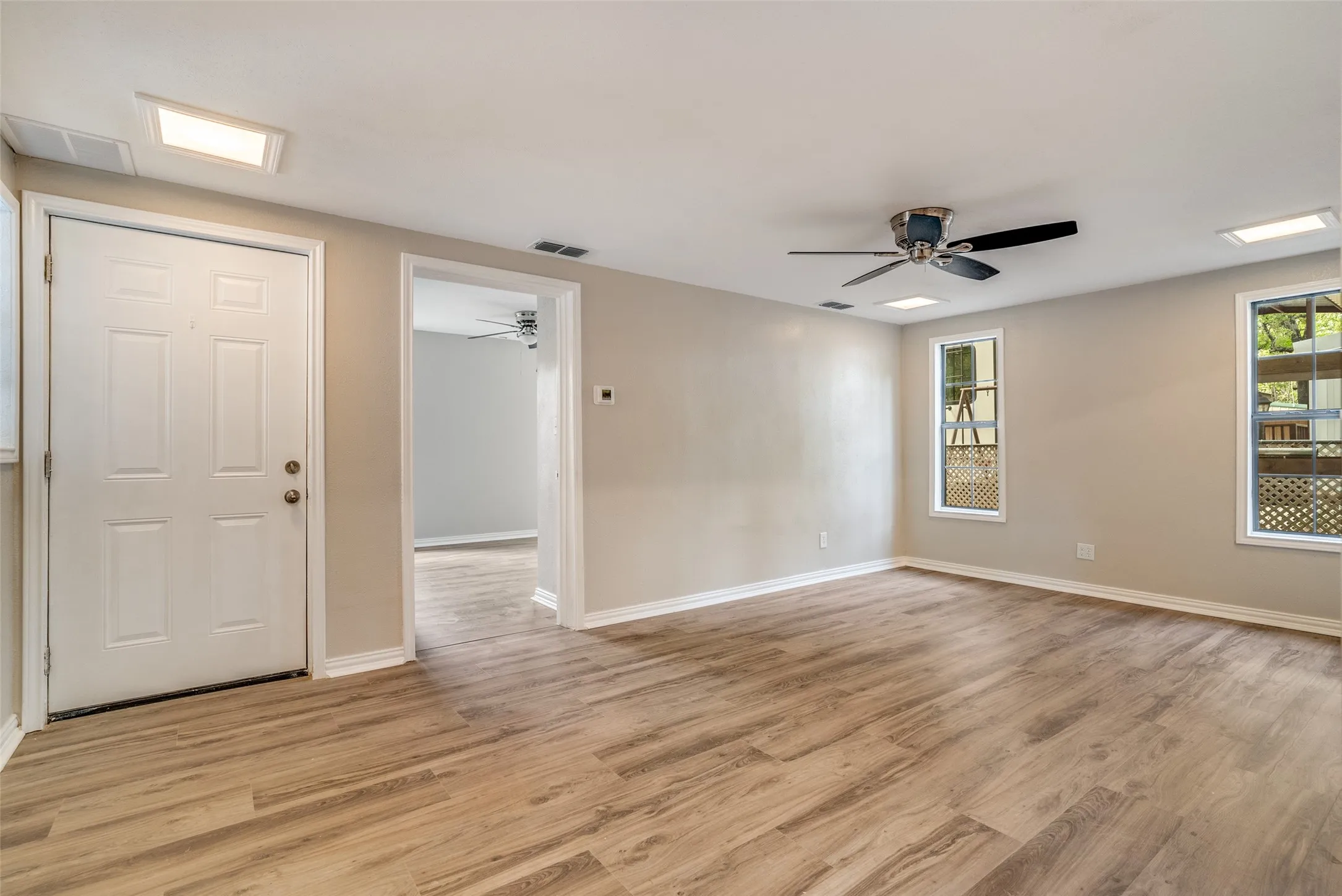 Unfurnished room with light wood-type flooring and ceiling fan