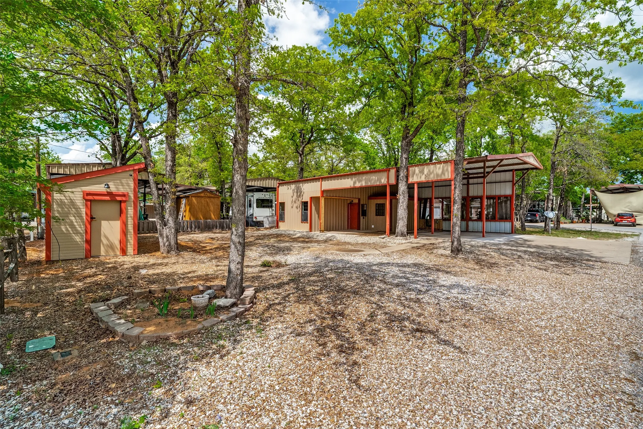 View of front of house with a storage shed