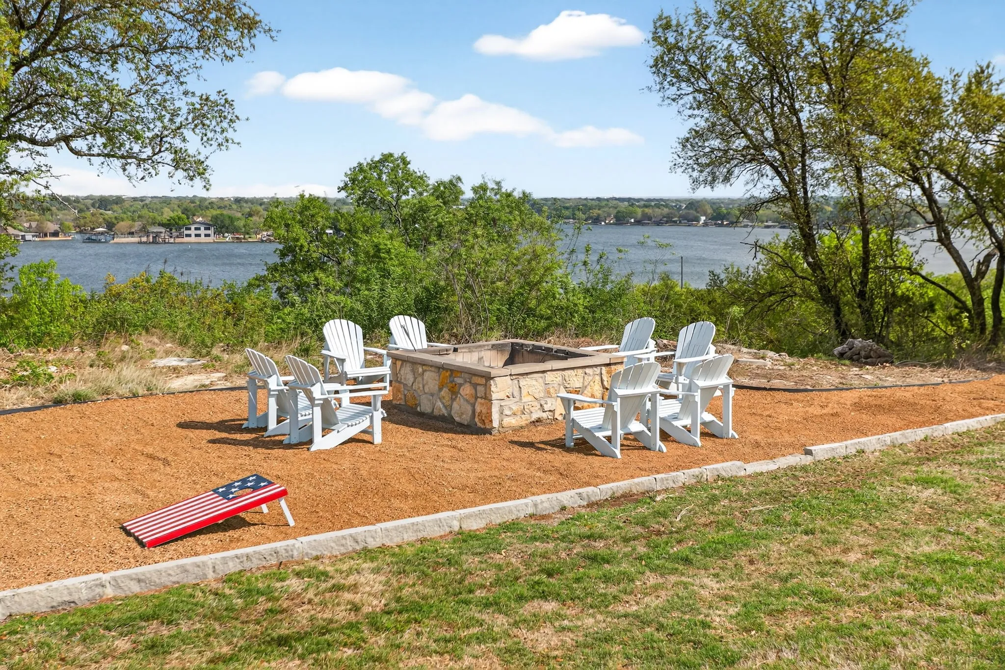 Step down the hill from the pool to the fire pit and game area.