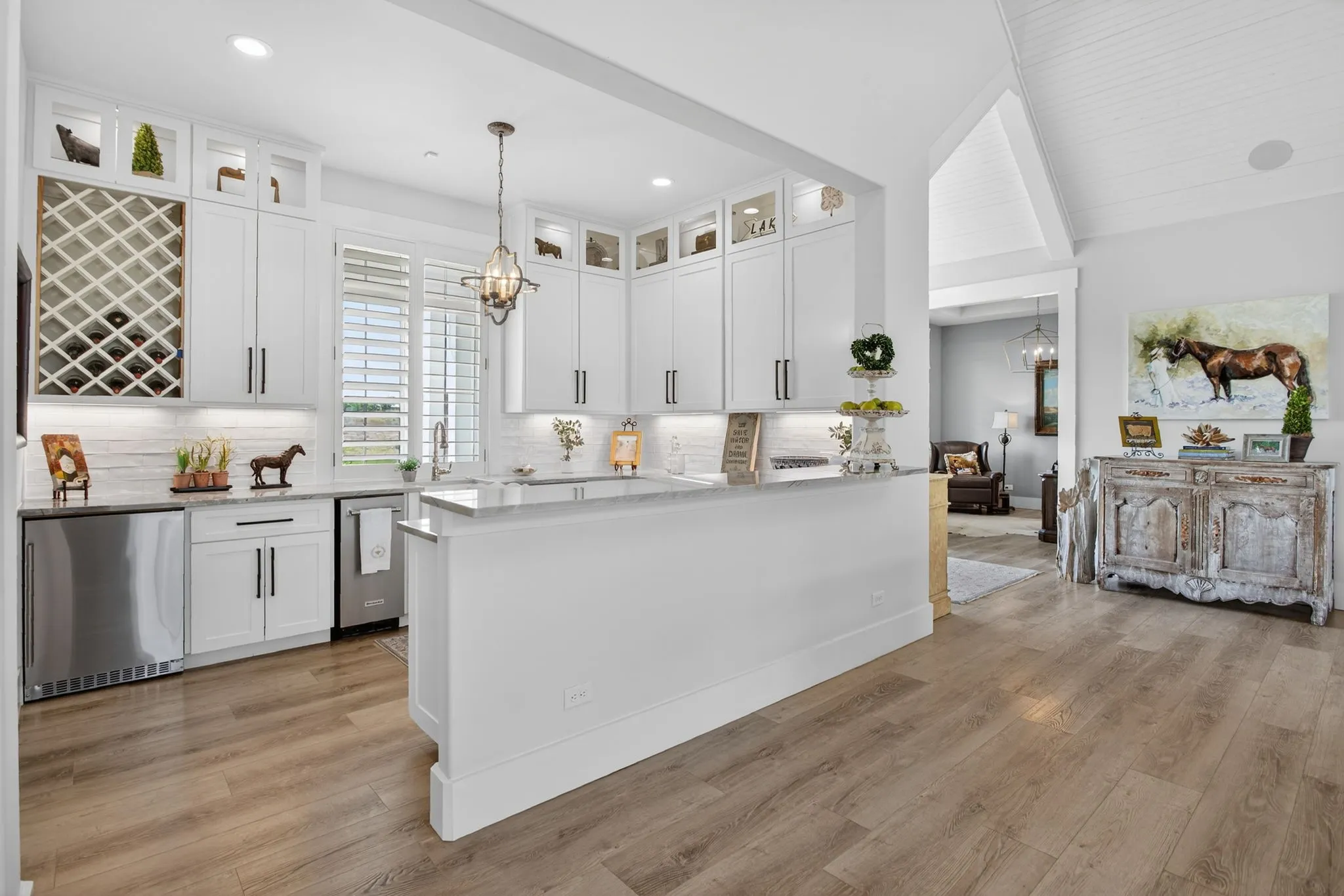 The entertainment bar has a refrigerator, ice machine, sink, wine refrigerator, and so much storage.
