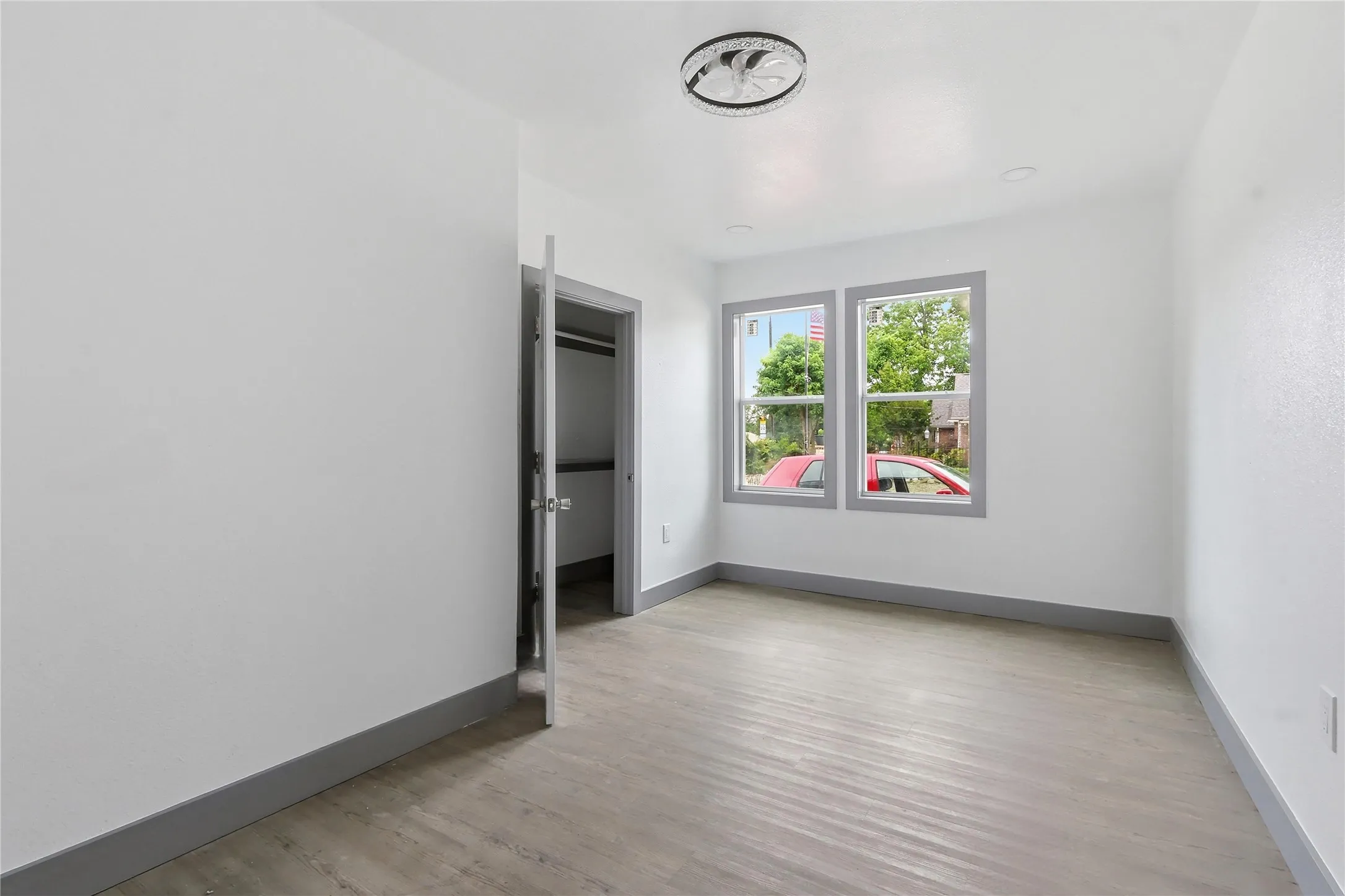 Light wood-finish flooring complements the neutral wall color in this room