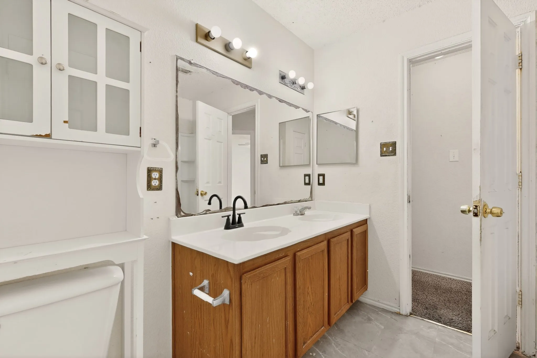 Full bathroom with toilet and double vanity