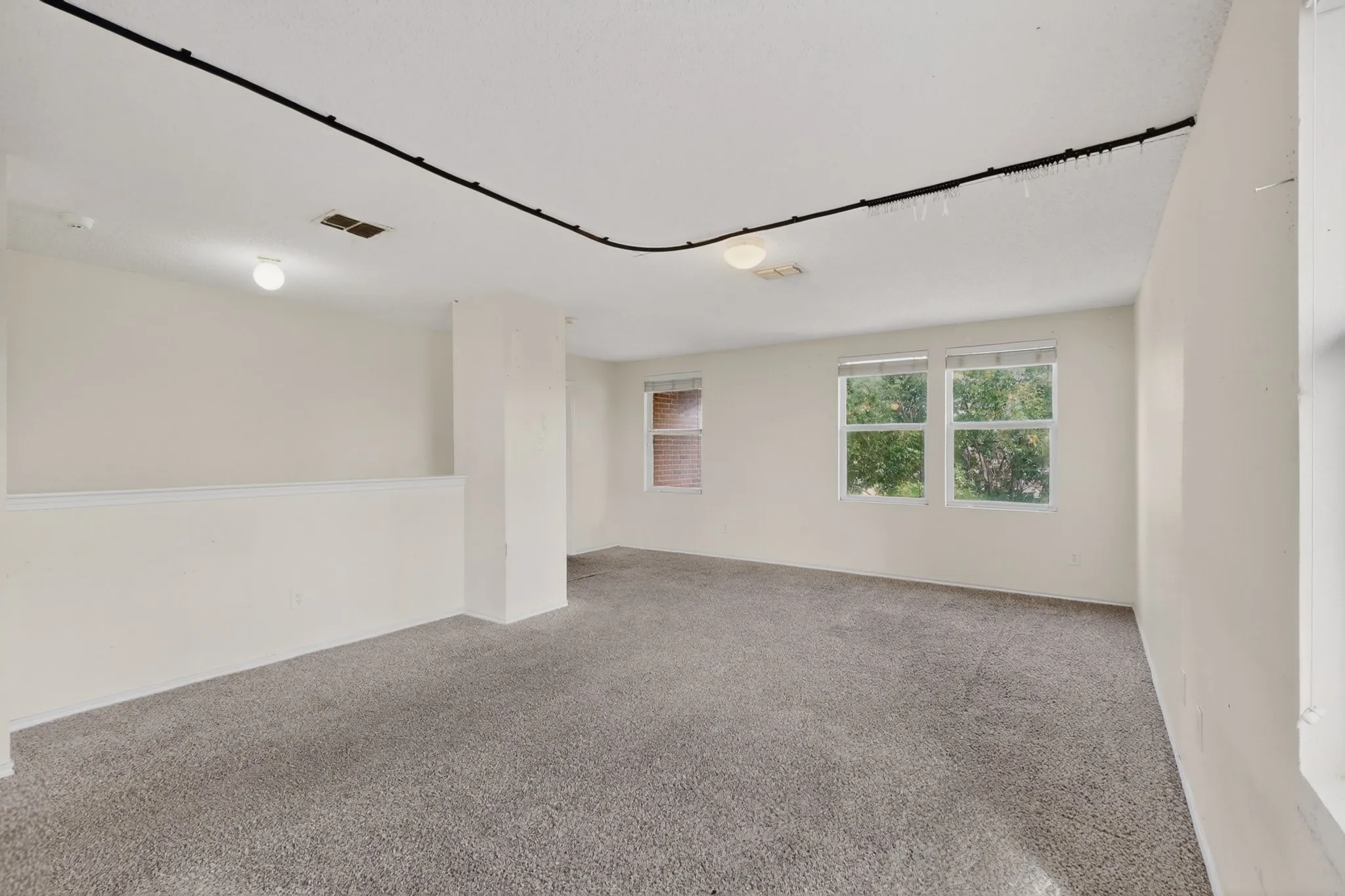 Unfurnished room with light carpet