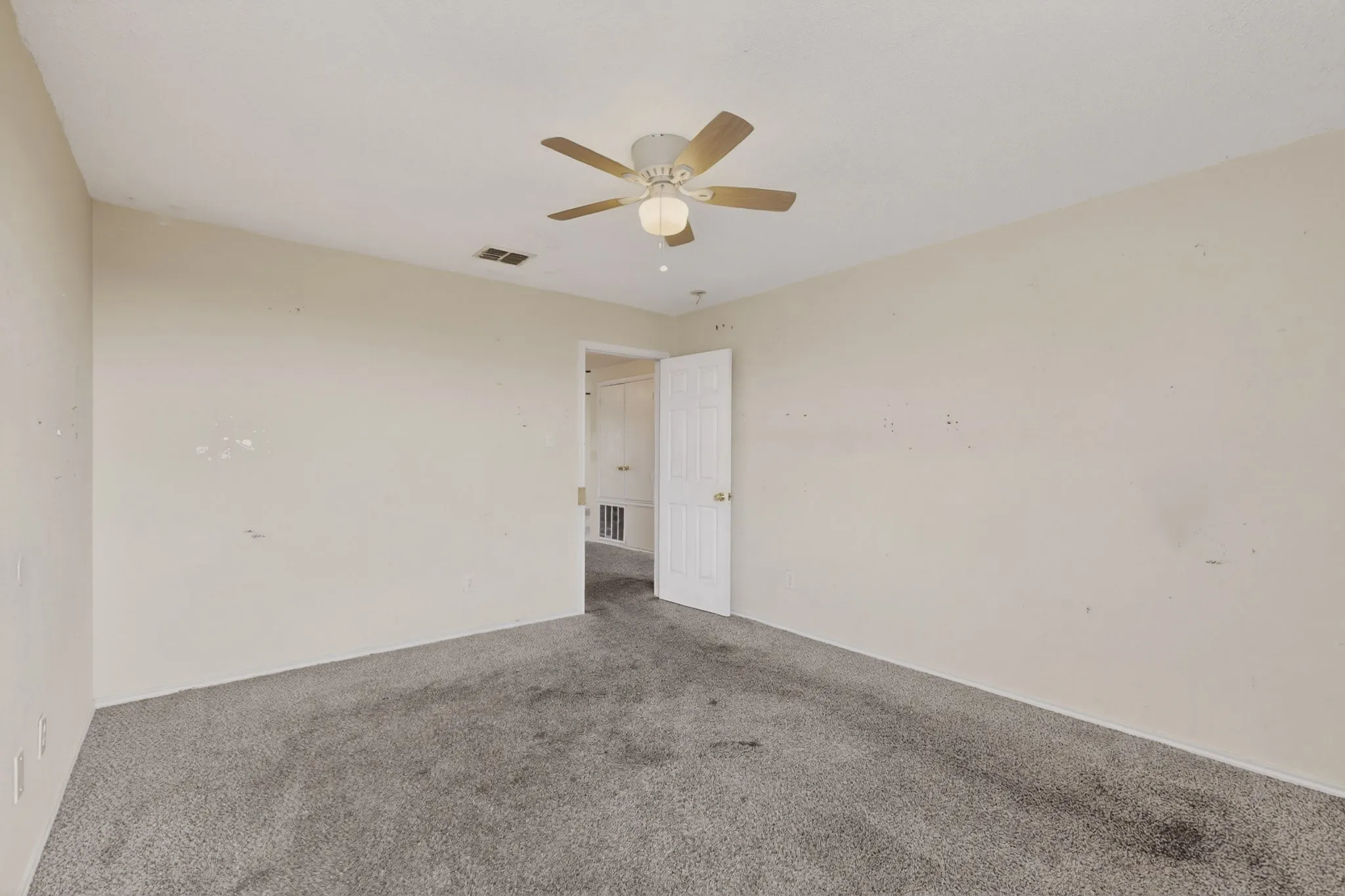 Unfurnished bedroom featuring carpet floors and ceiling fan