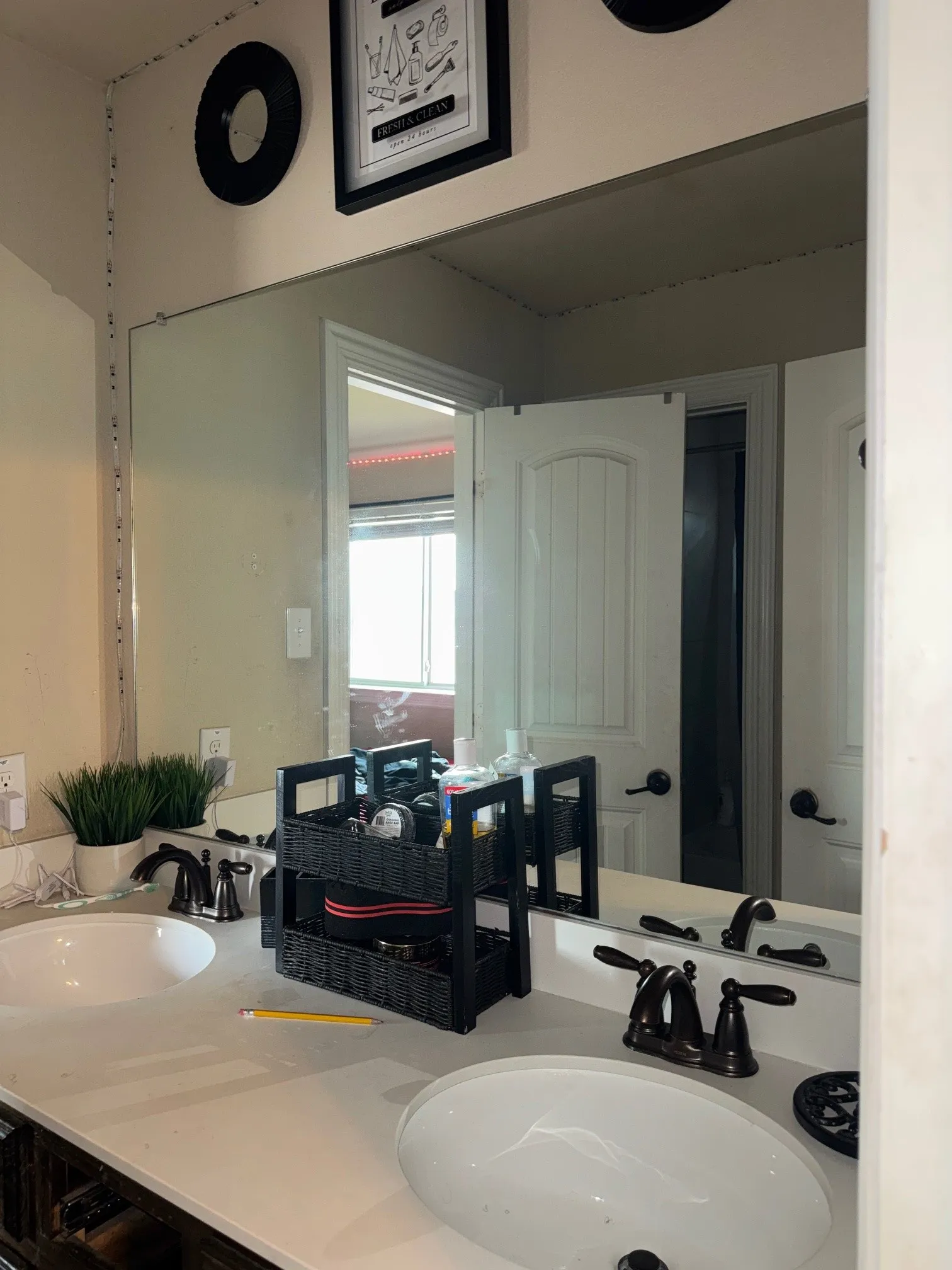 Dual undermount sinks set into a light-colored countertop with oil-rubbed bronze fixtures