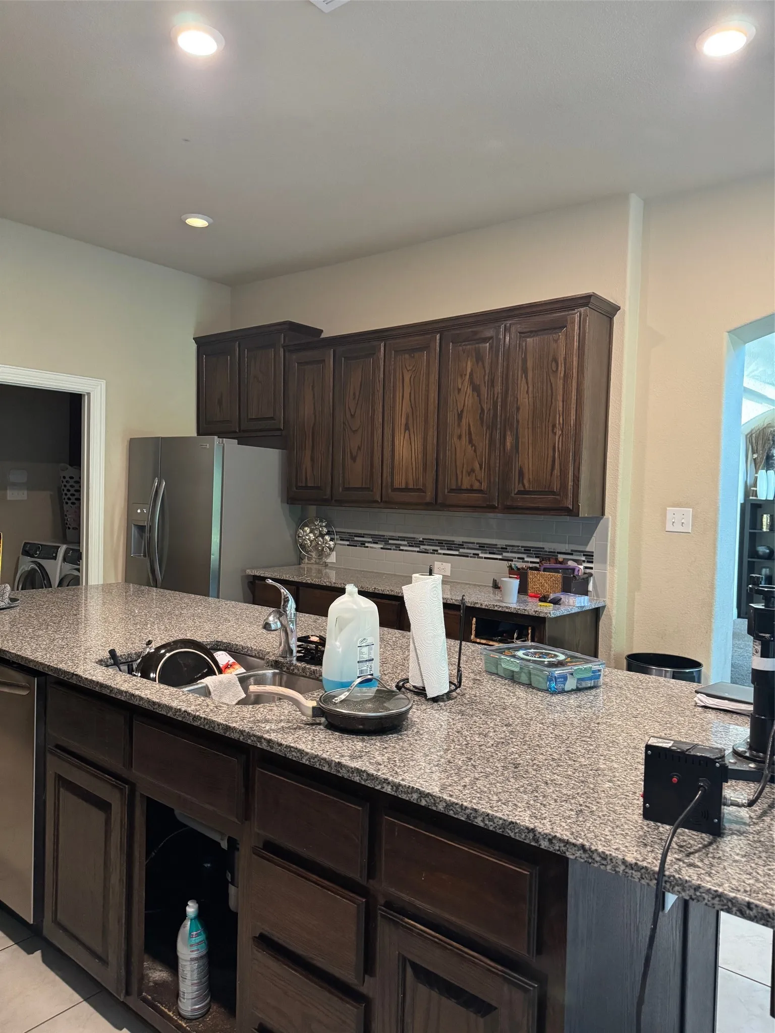 Granite countertop island with an undermount sink and a stainless steel dishwasher