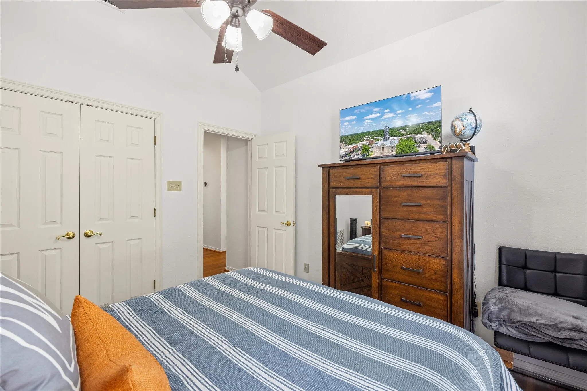 Bedroom with a closet, lofted ceiling, and ceiling fan