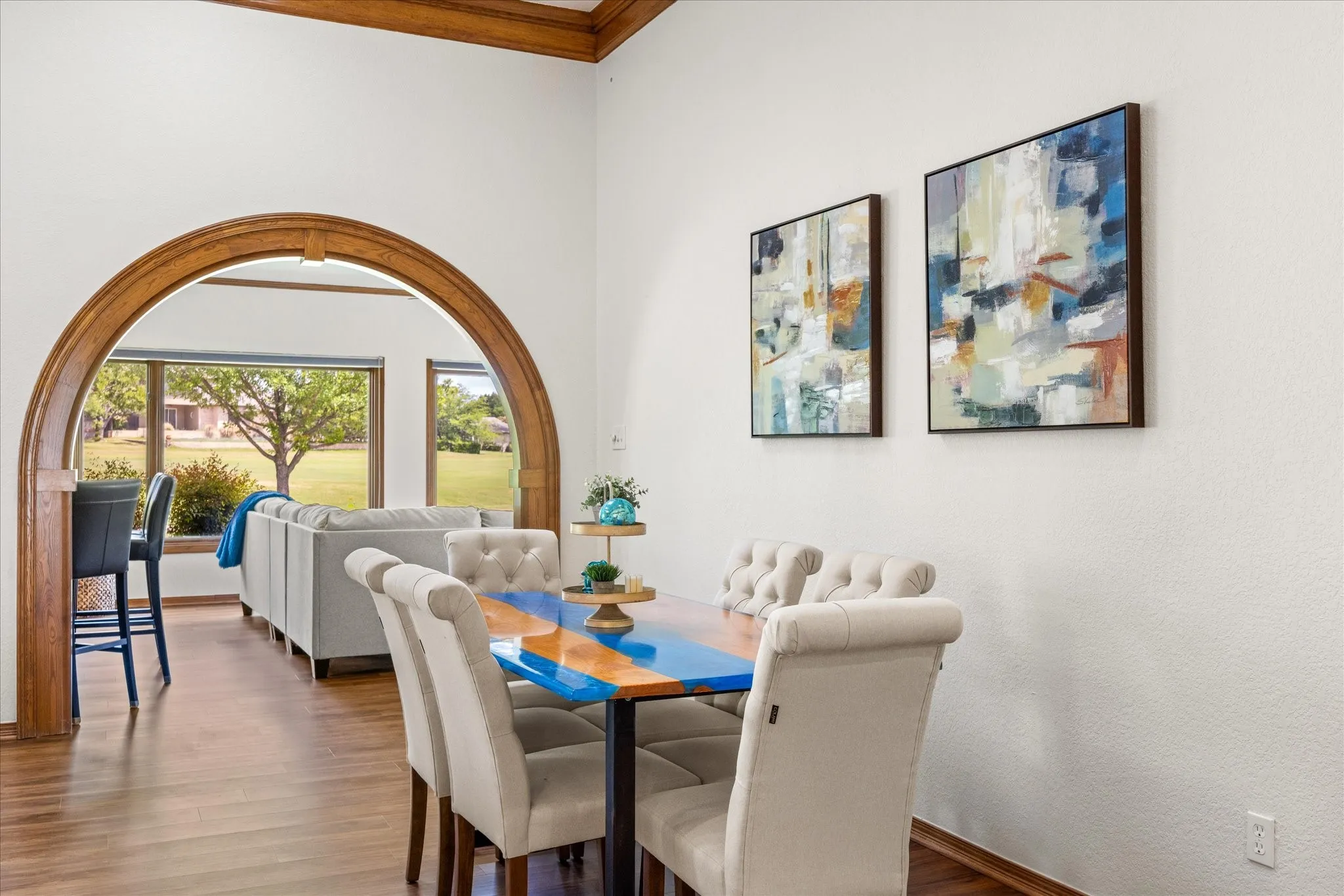 Dining space with crown molding and wood finished floors
