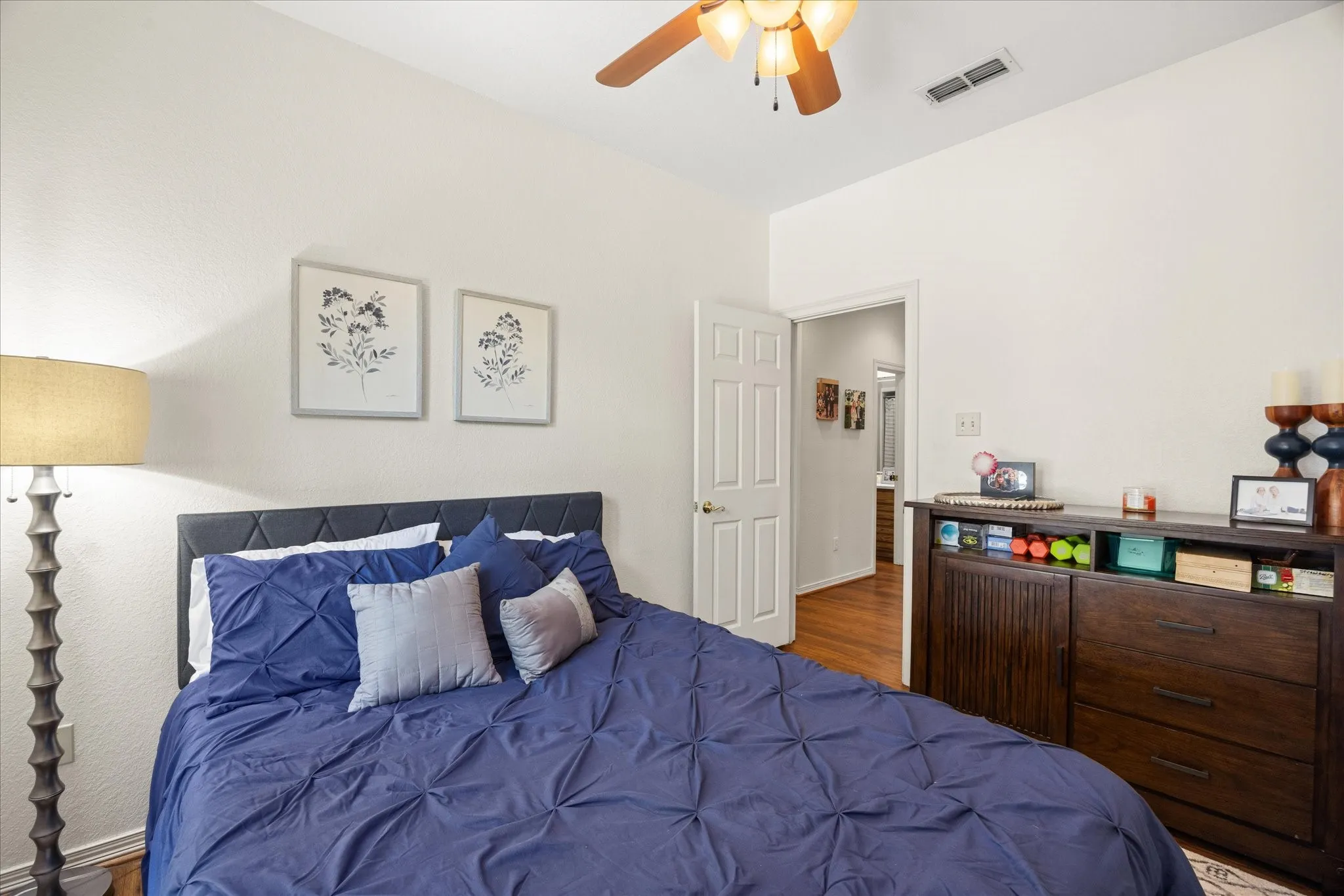 Bedroom with a ceiling fan and dark wood-style floors