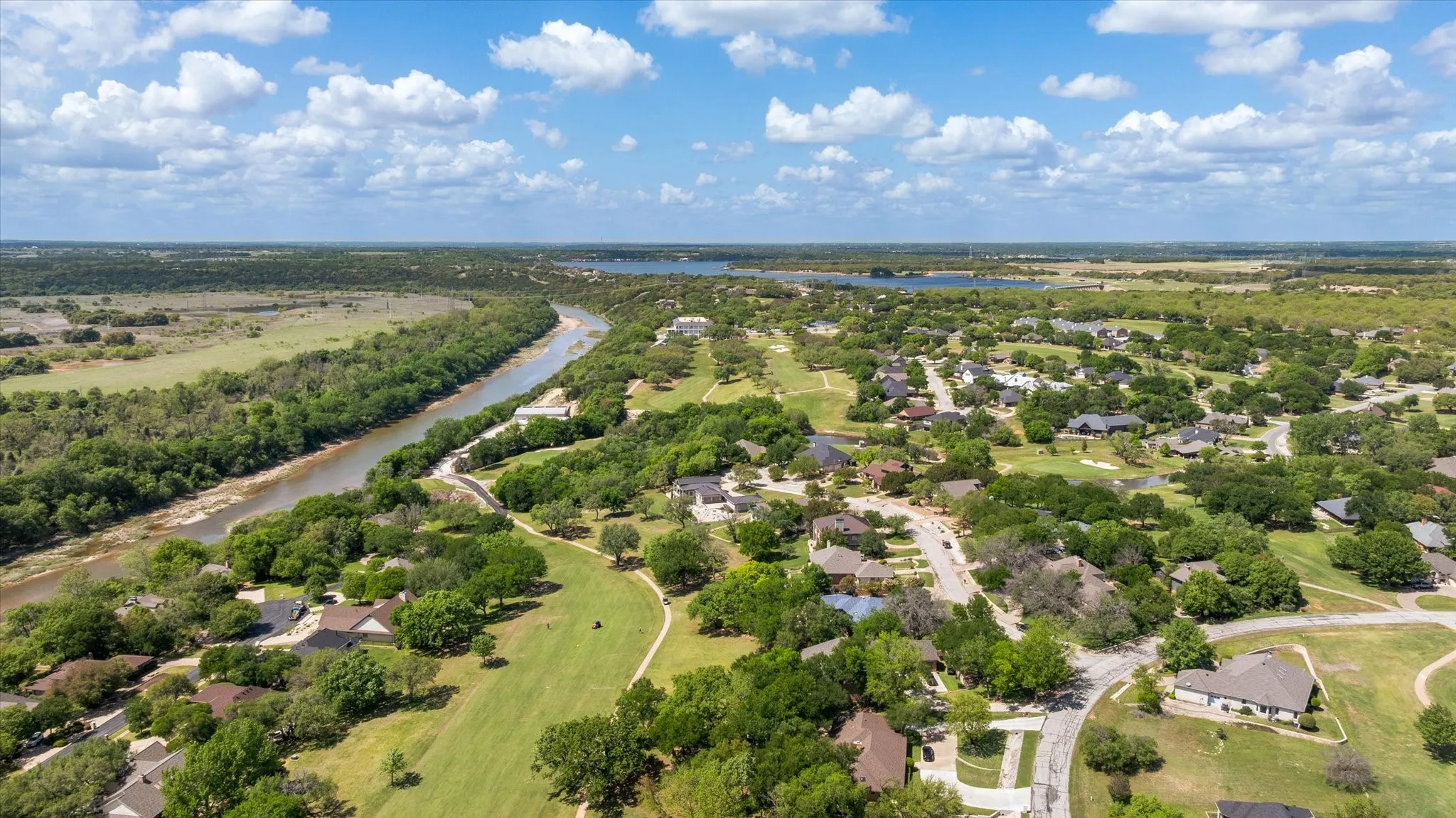 Aerial perspective of suburban area with a large body of water