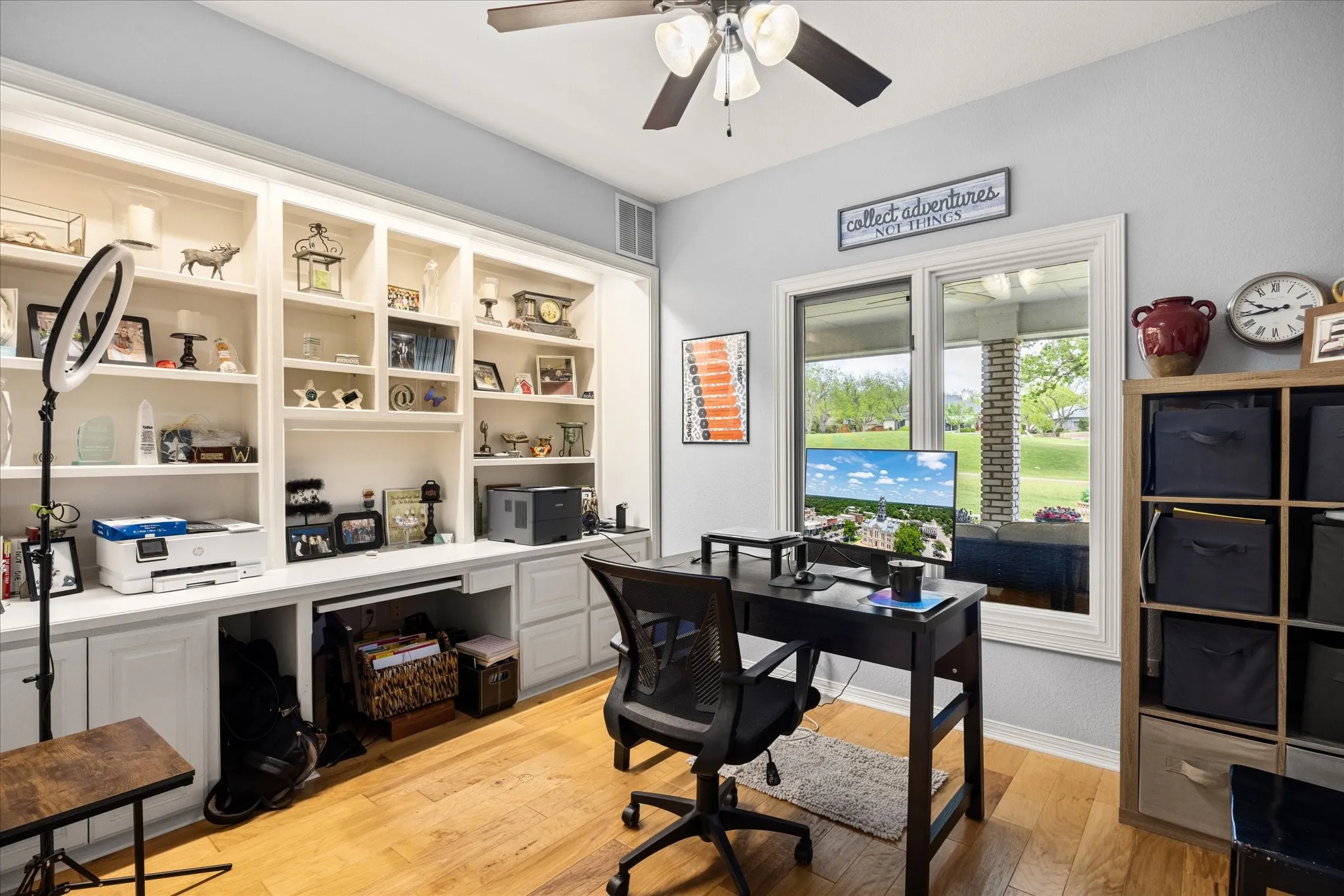 Home office featuring light wood finished floors and a ceiling fan