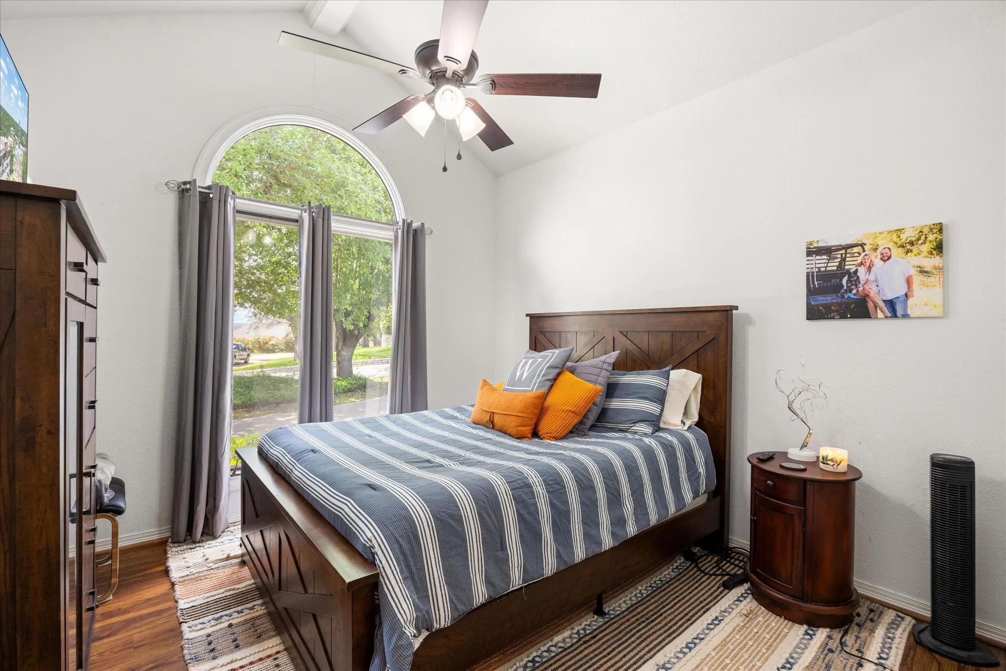 Bedroom featuring wood finished floors, vaulted ceiling, and ceiling fan