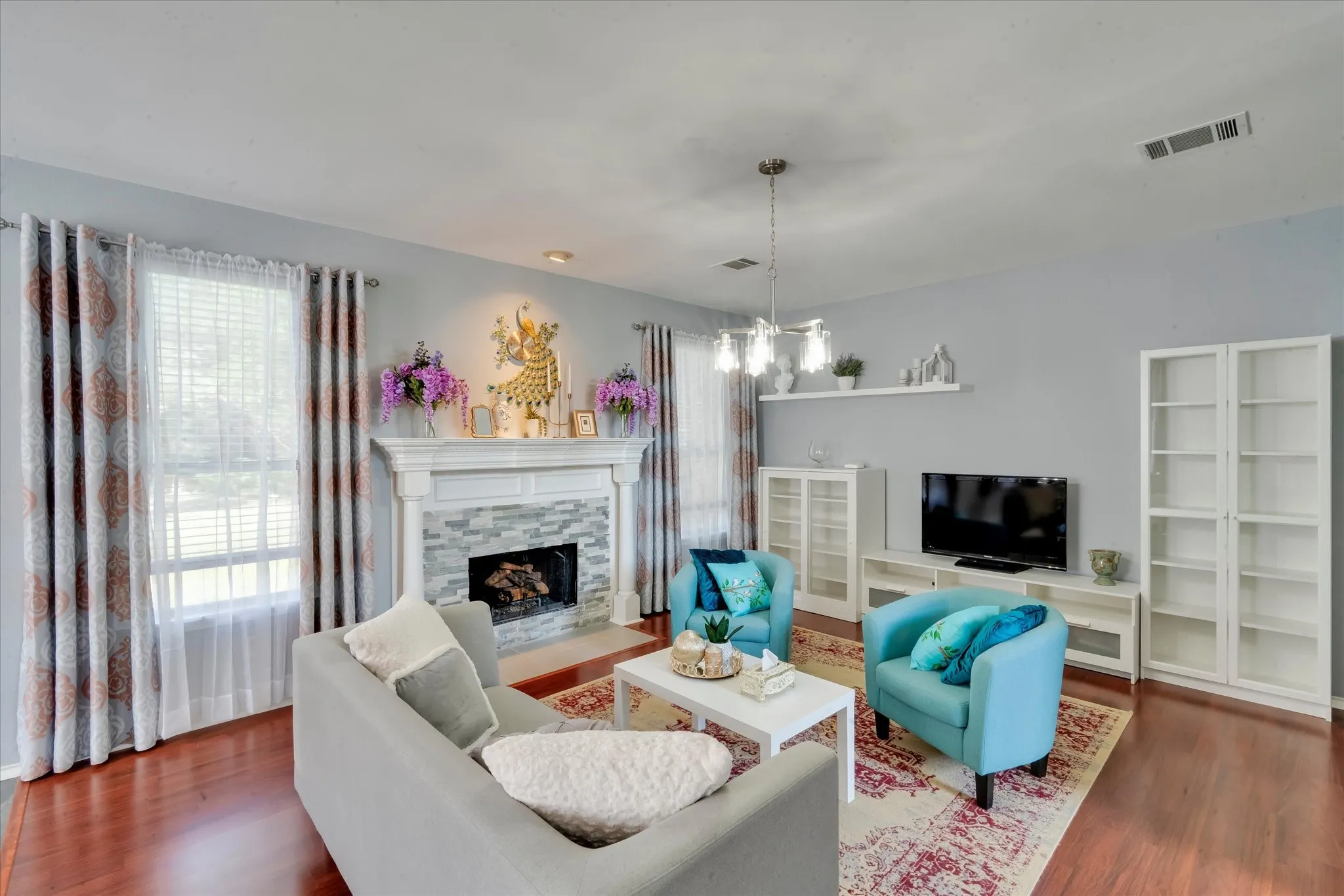 Family room with brand new flooring, beautiful stone fireplace with custom mantel makes this room standout.