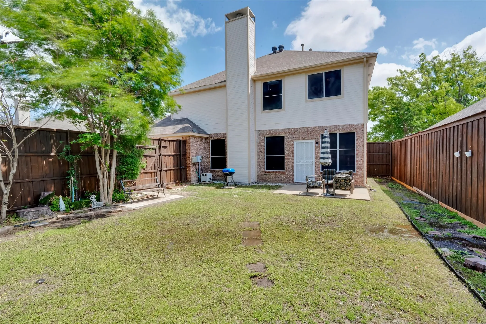 Spacious backyard fully landscaped with shed and swing set