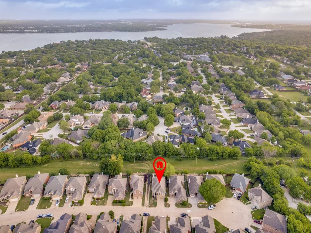 Aerial view of property's location featuring nearby suburban area and a nearby body of water