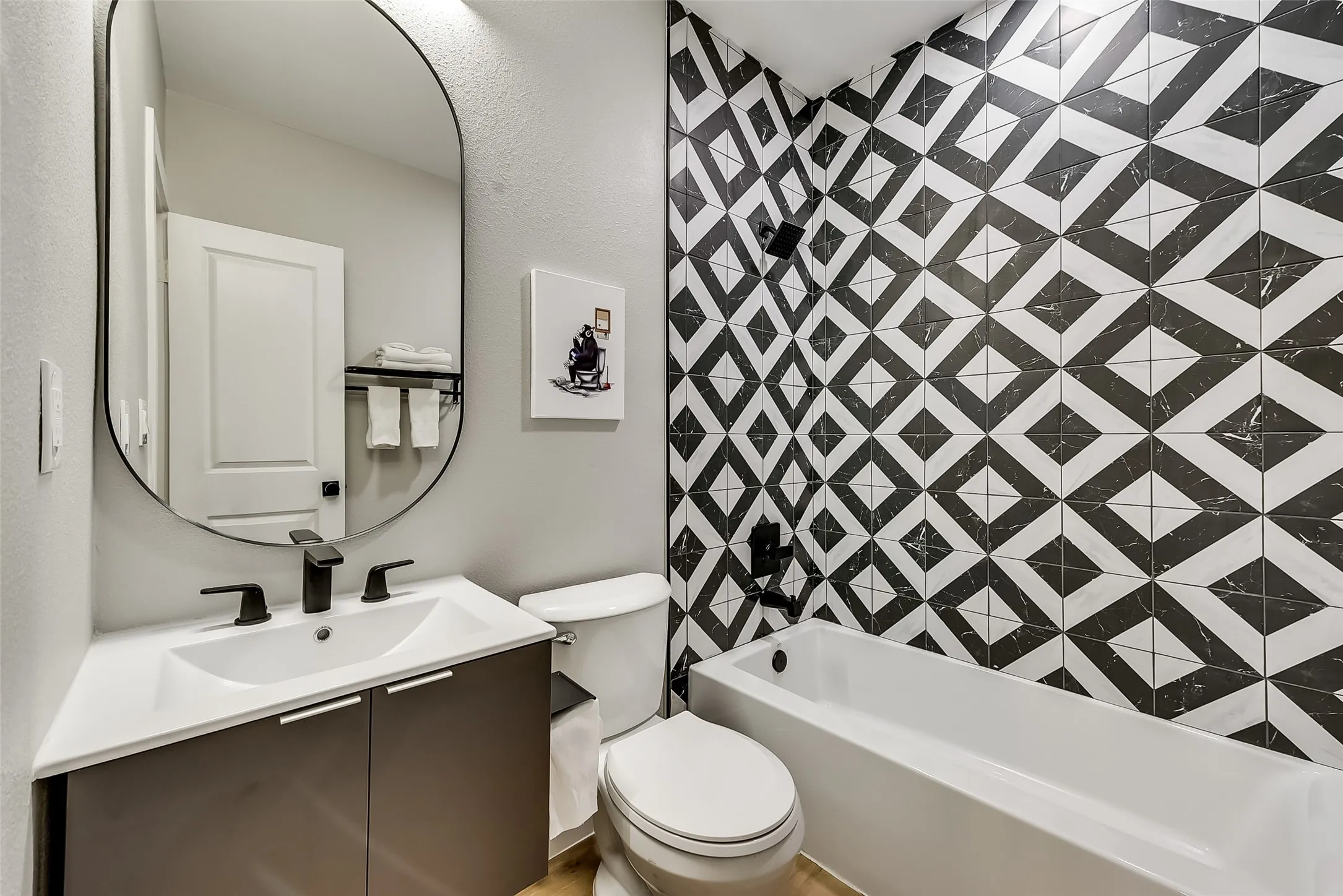 Full bathroom featuring toilet, washtub / shower combination, and vanity