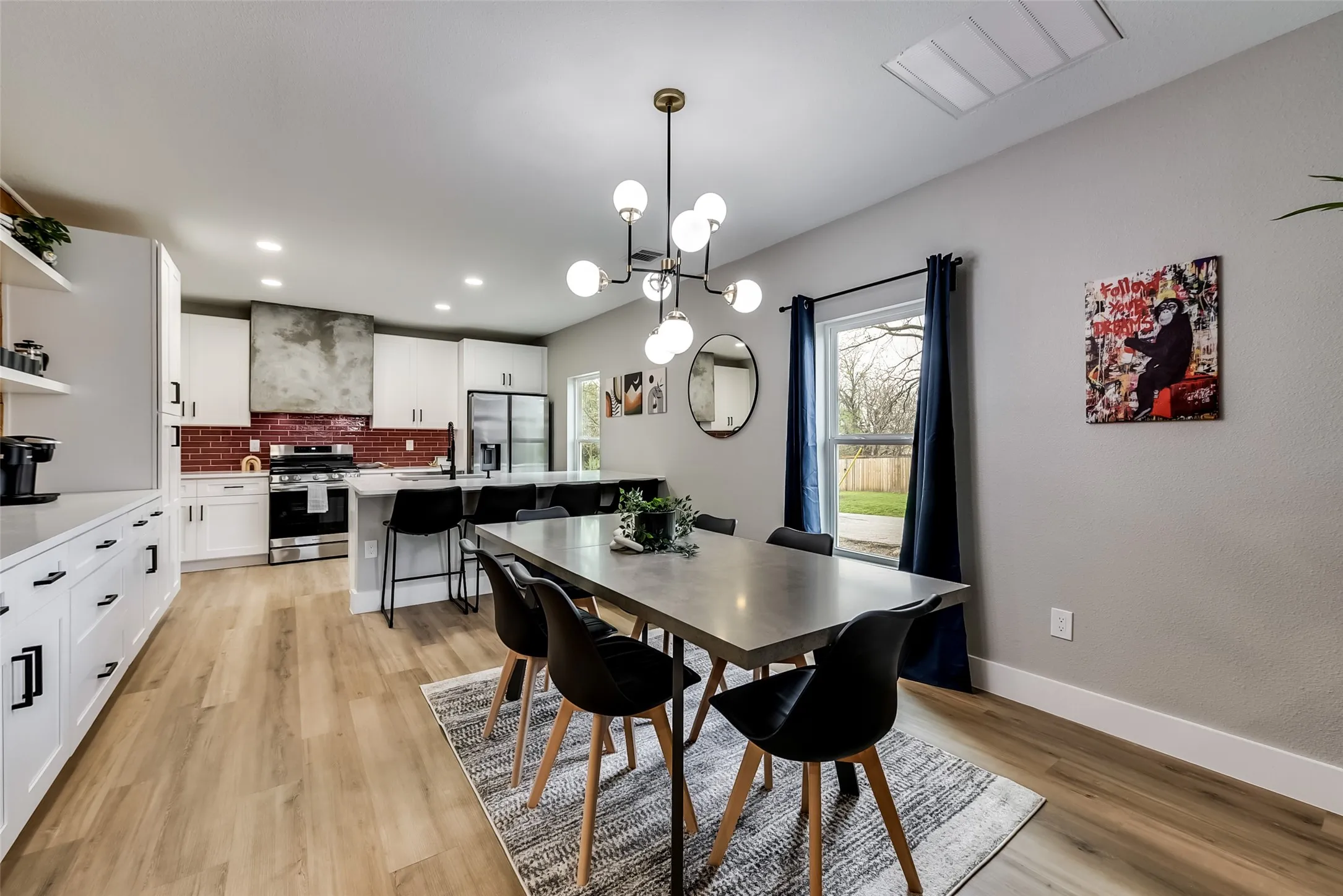 Dining area with light wood-type flooring, visible vents, baseboards, a chandelier, and recessed lighting