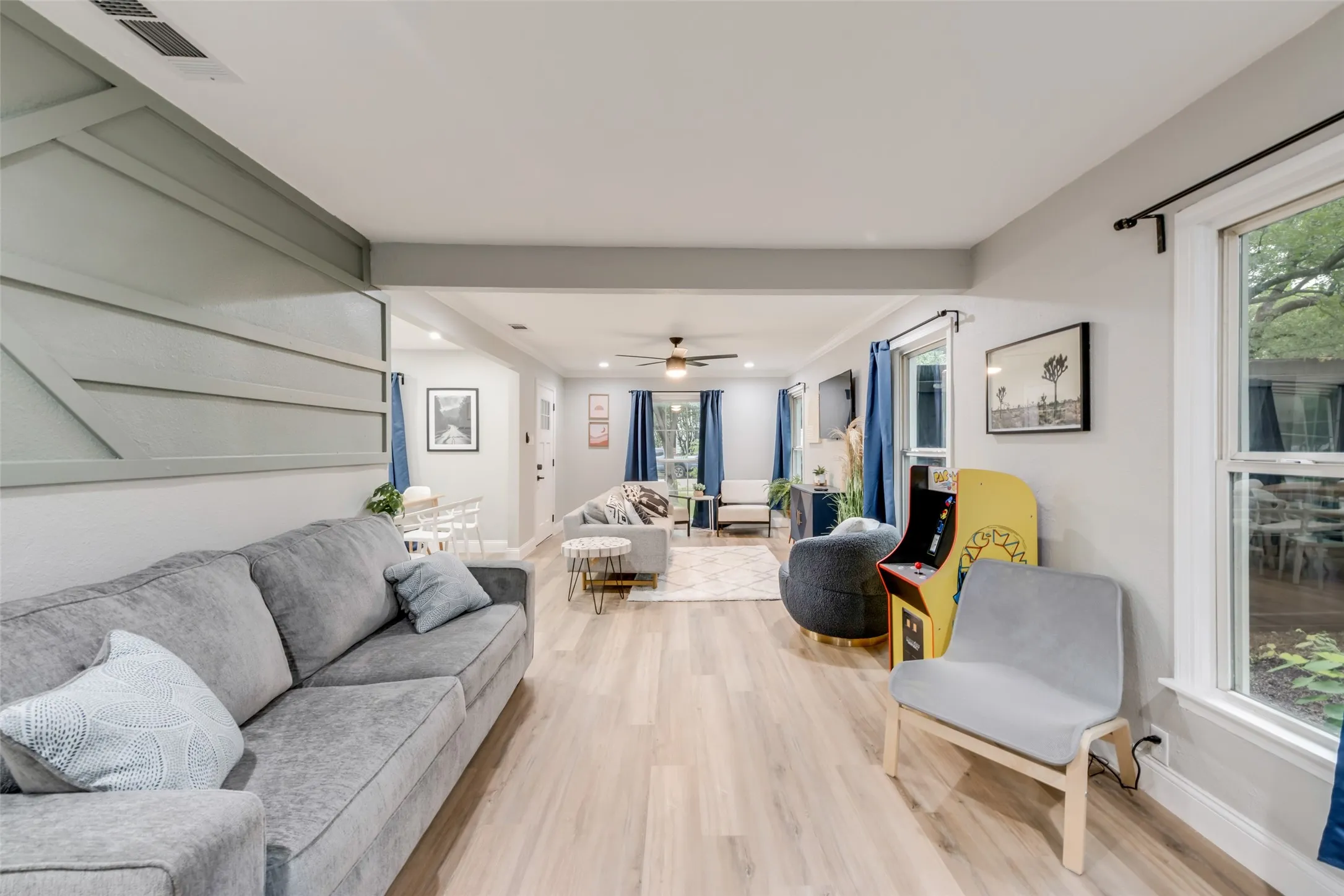 Living room featuring light wood finished floors, ceiling fan, and recessed lighting