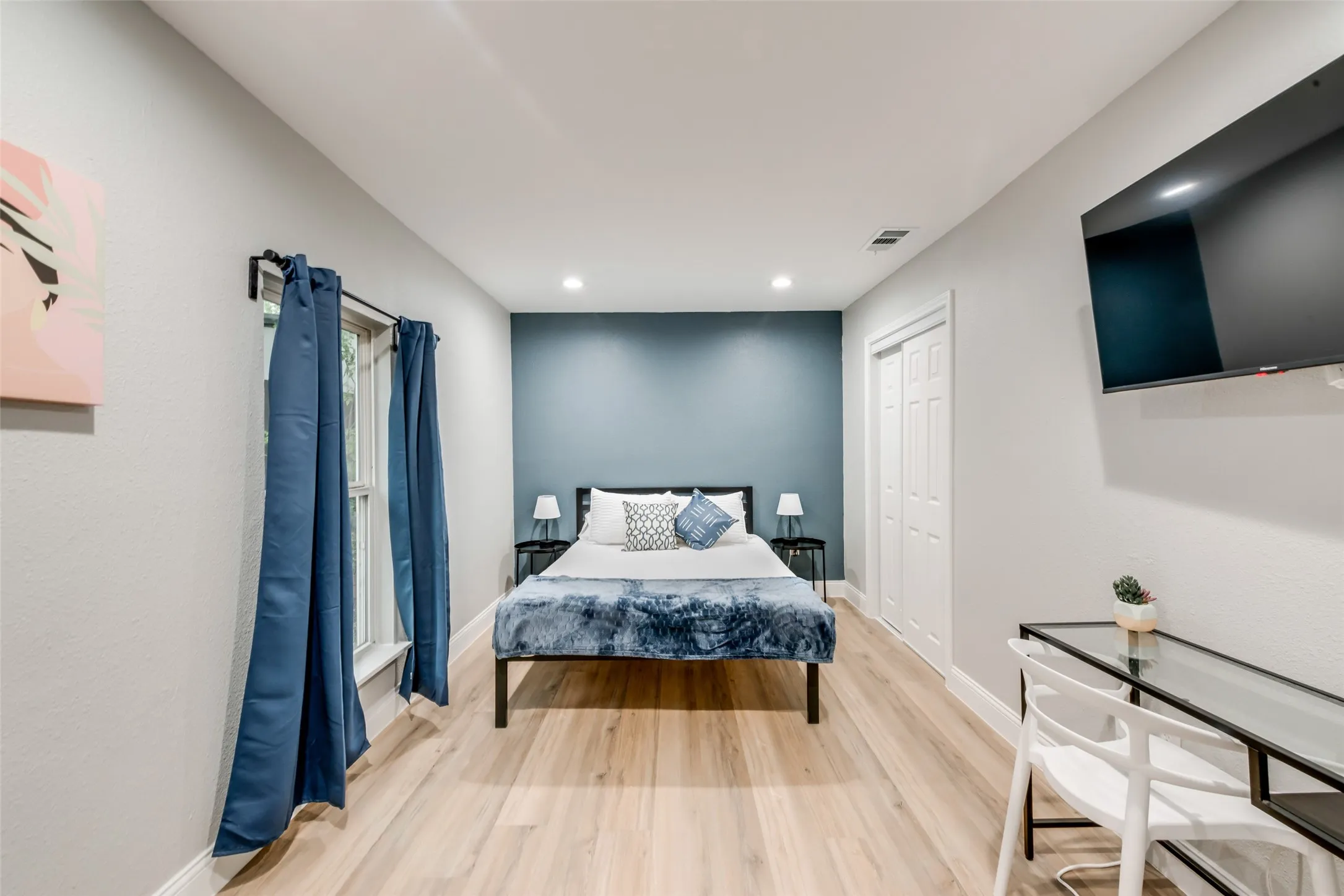 Bedroom featuring light wood-style flooring, recessed lighting, and a closet
