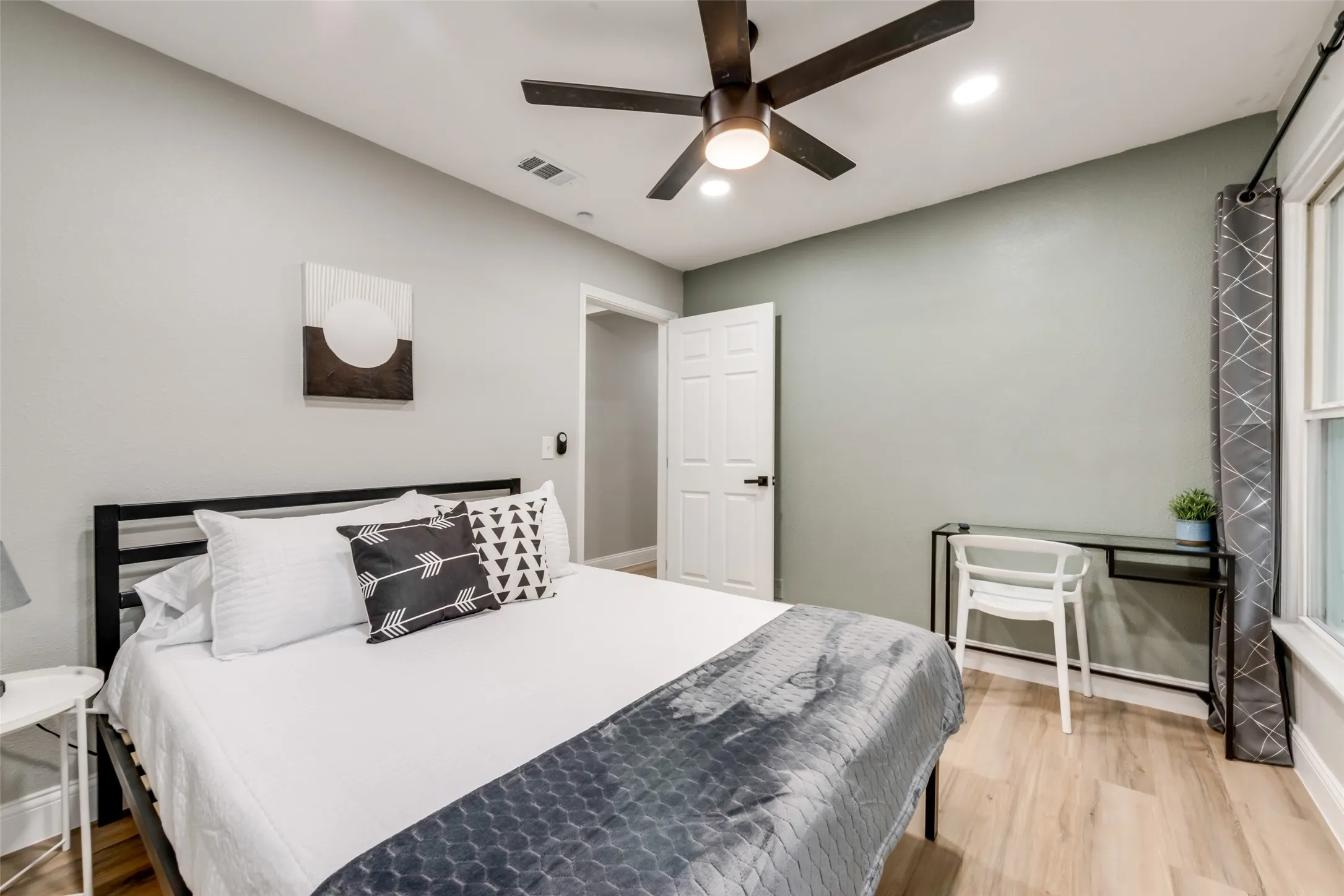Bedroom featuring light wood-type flooring, a ceiling fan, and recessed lighting