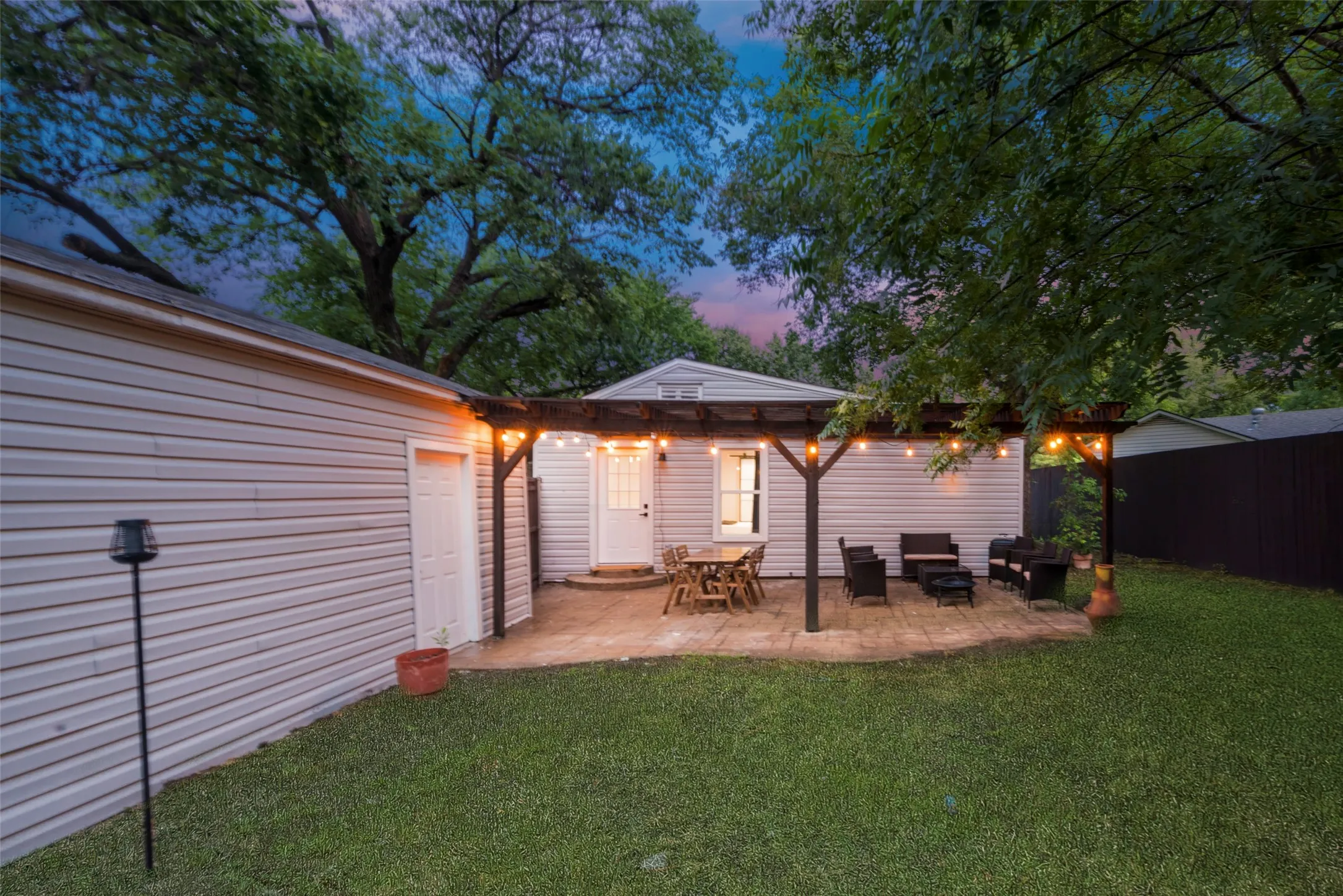 Rear view of house with a yard, a patio area, and an outdoor living space