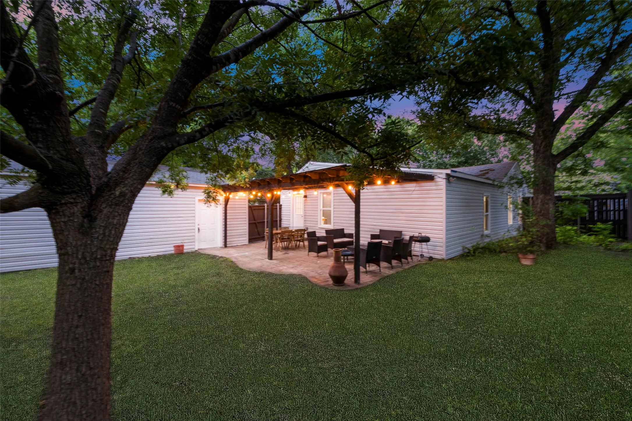 Back of house with a lawn, a patio, and an outdoor hangout area