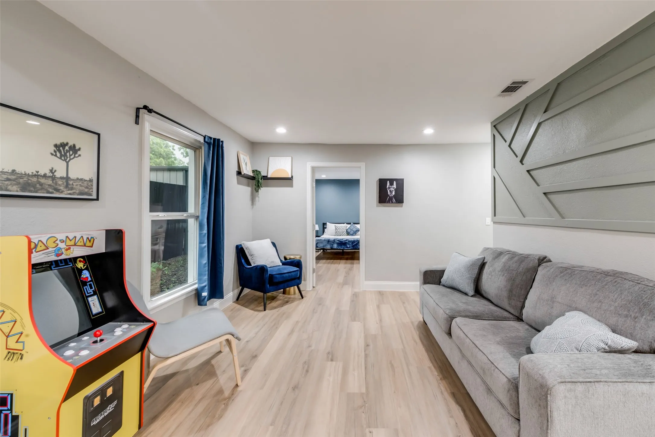 Living area featuring light wood-style floors and recessed lighting