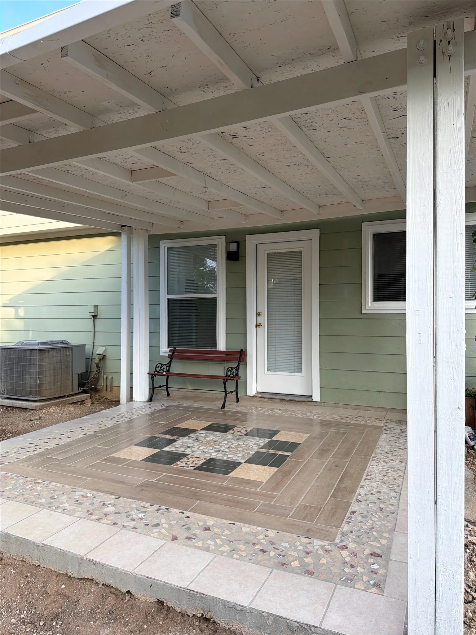 Property entrance with a patio