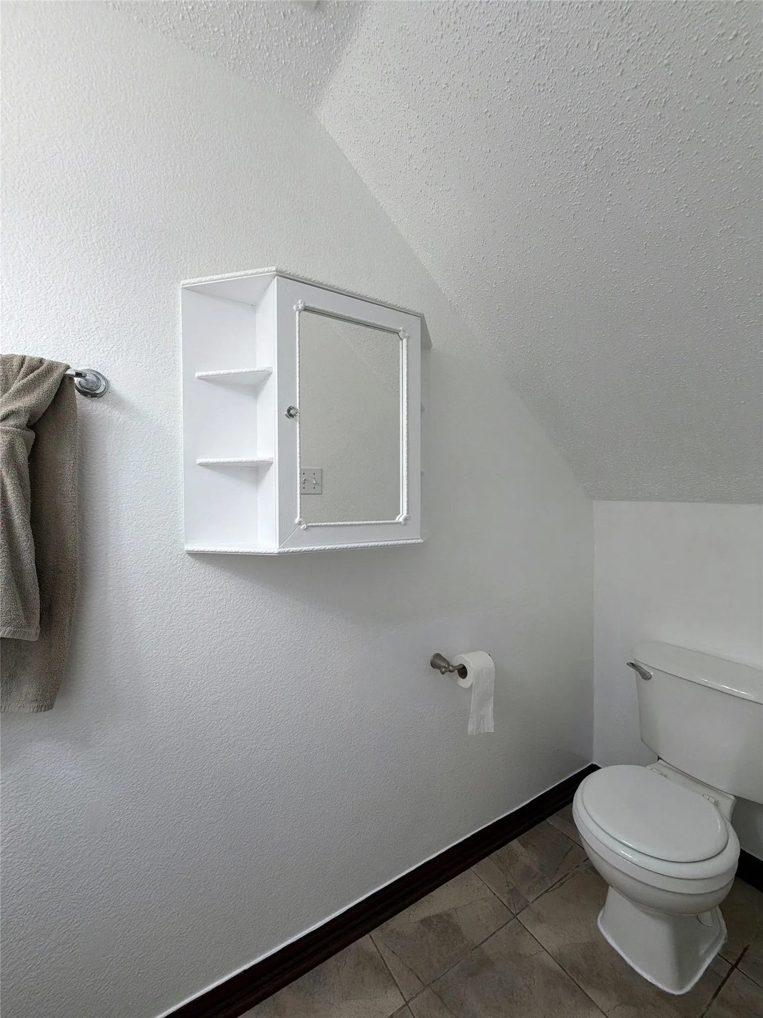 Half Bath with toilet and baseboards