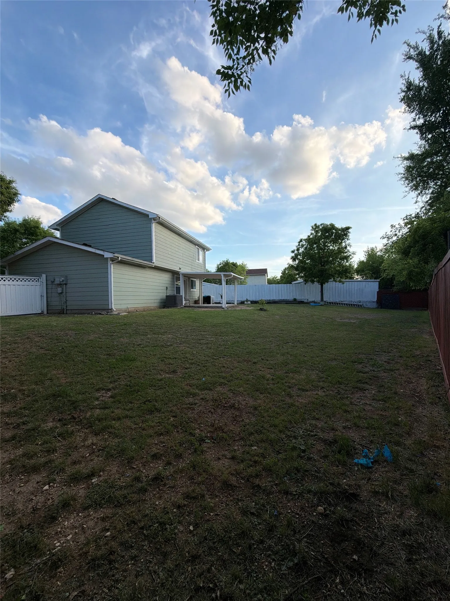 Fenced backyard with a patio
