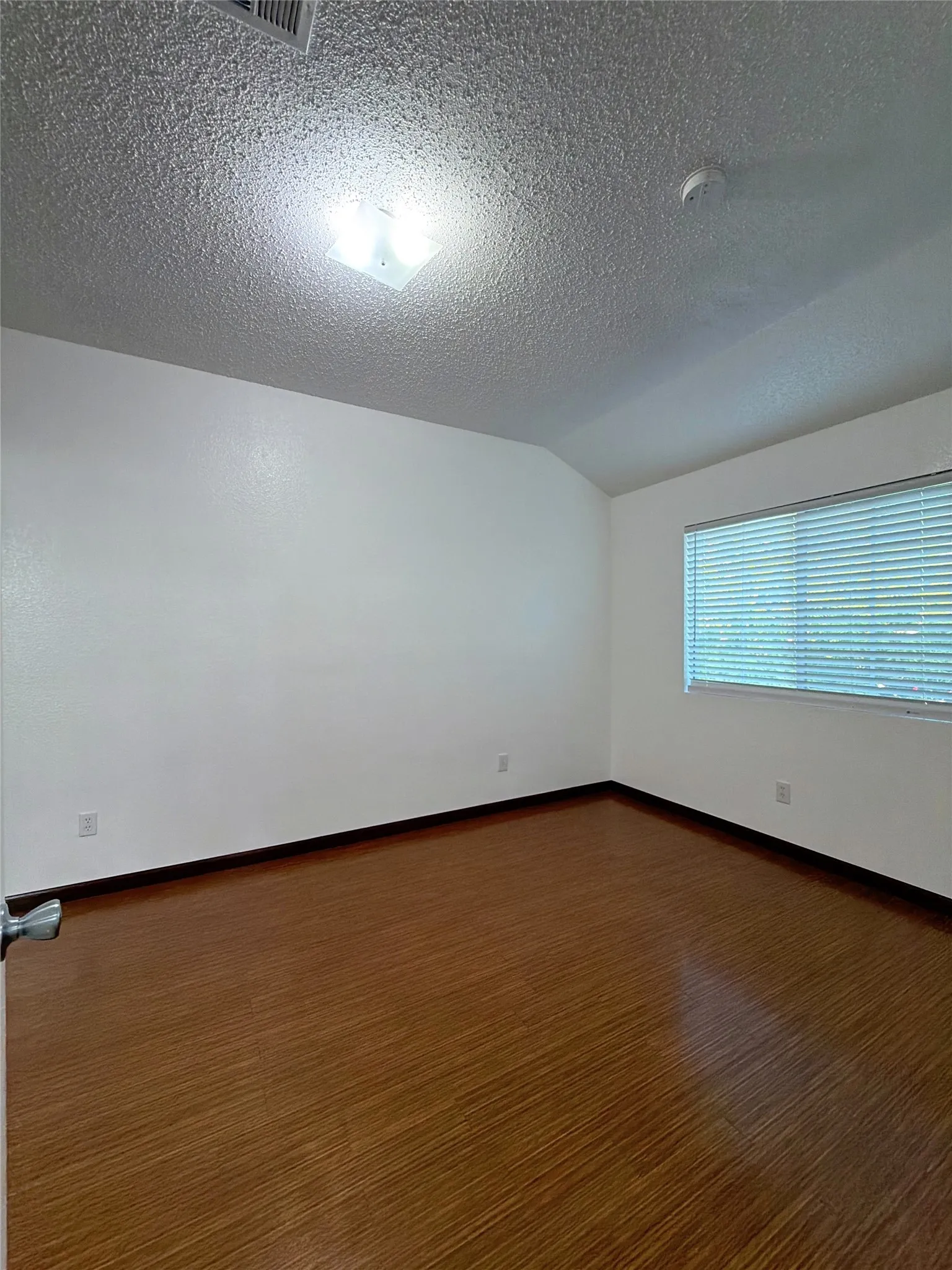 Unfurnished room featuring wood finished floors