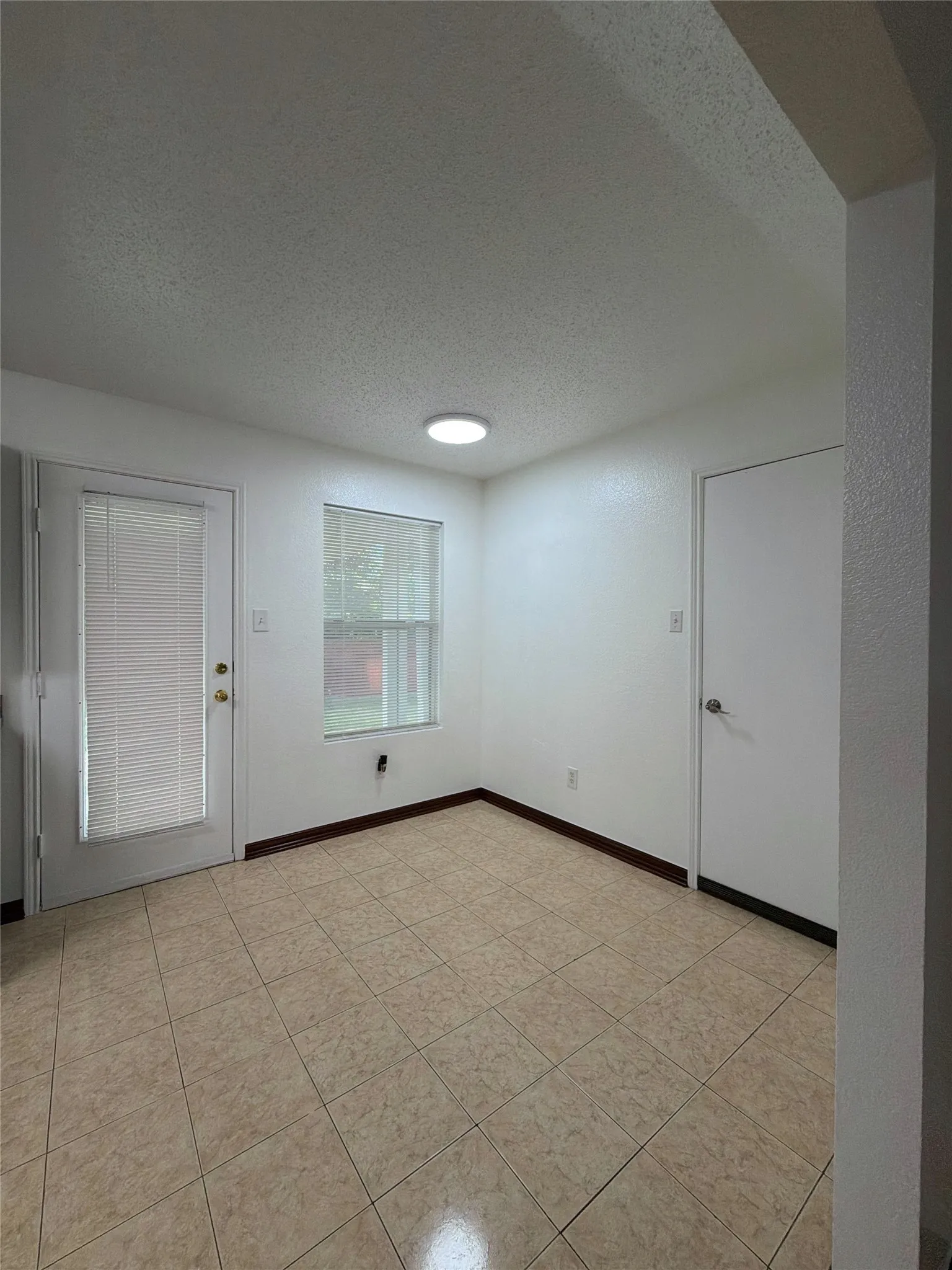 Dining room featuring a textured ceiling and light tile patterned floors