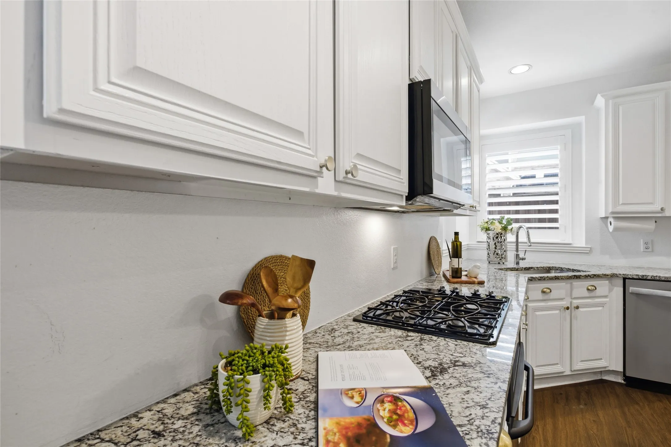Gorgeous natural stone granite counter tops and gas cooktop.