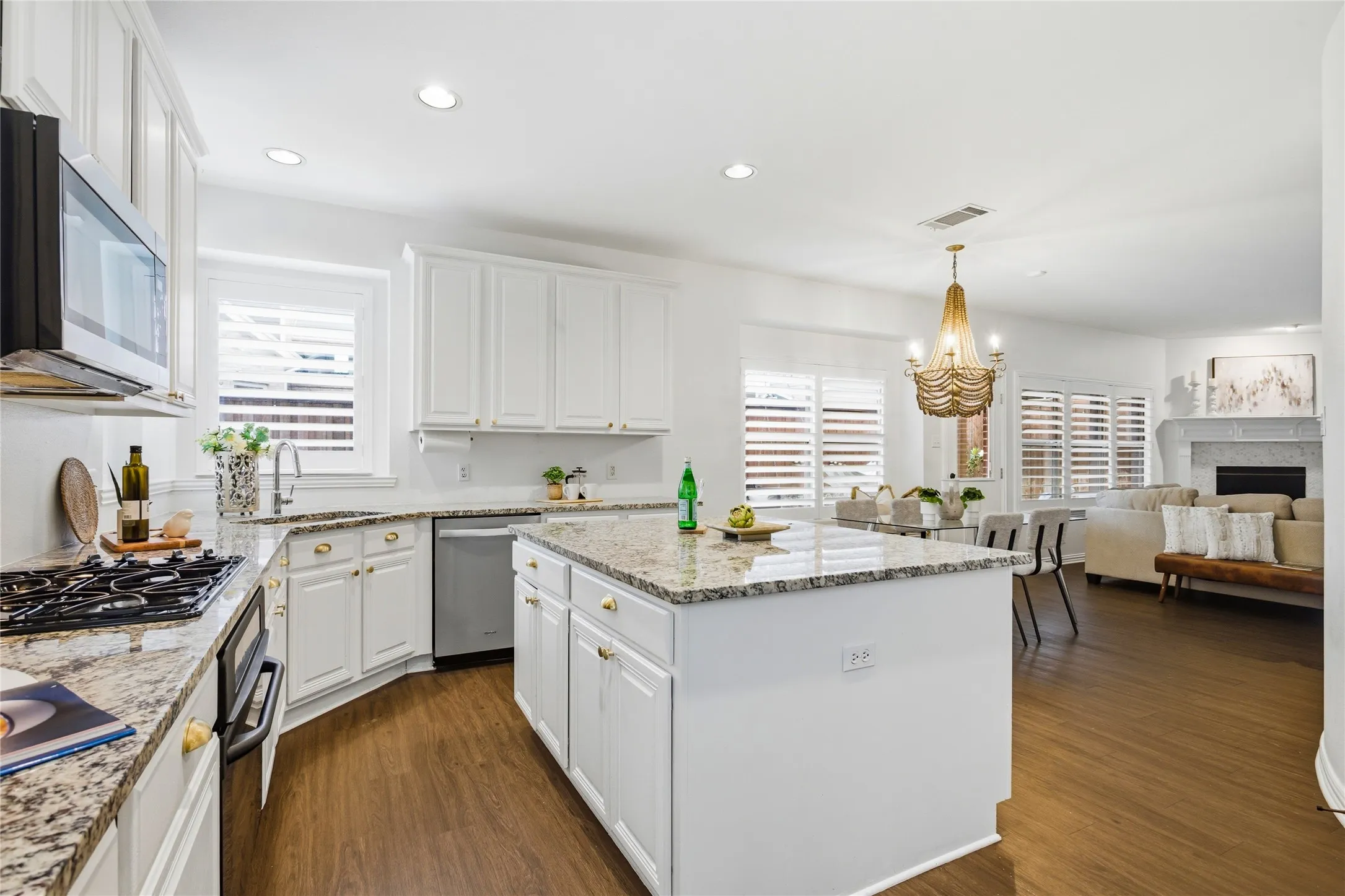 Big kitchen. Chef's dream with all of the sprawling granite countertops. So much workspace to prep meals and entertain. Gas cooktop, dishwasher, disposal, stainless steel sink, and built in microwave. Plant lovers will love the window space behind sink for herbs and other plants.