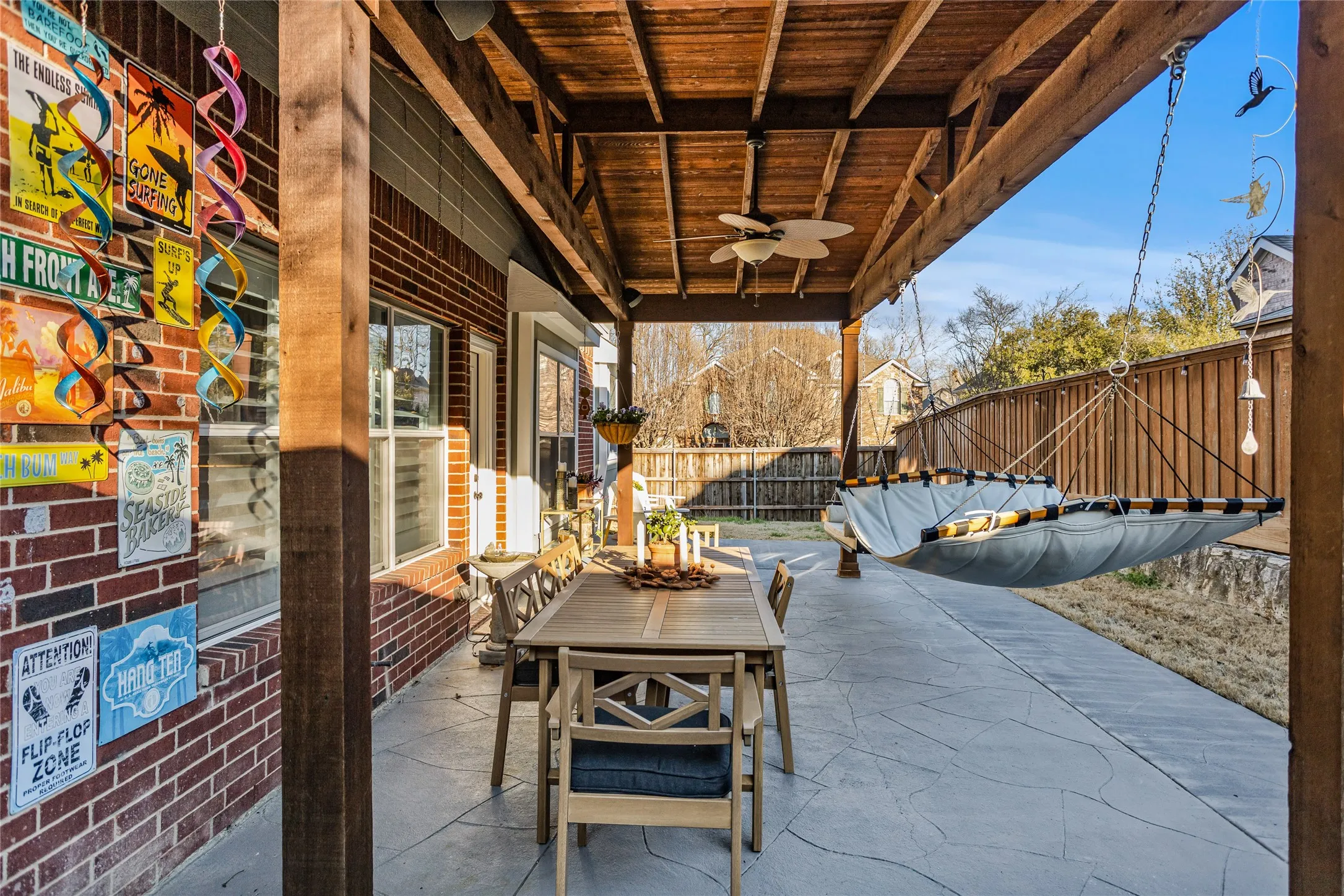 Expanded wood covered patio. Lots of room for entertaining. The swing, hammock, chair and ottoman  stay!