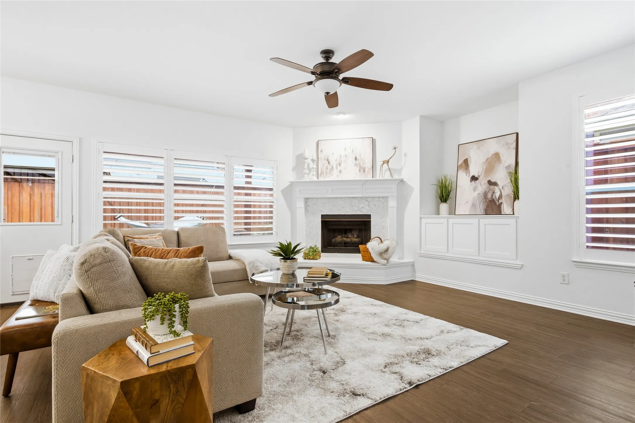 Family room has lots of natural light with plantation shutters, cozy gas fireplace, entertainment nook with built in cabintry for entertainment equipment.