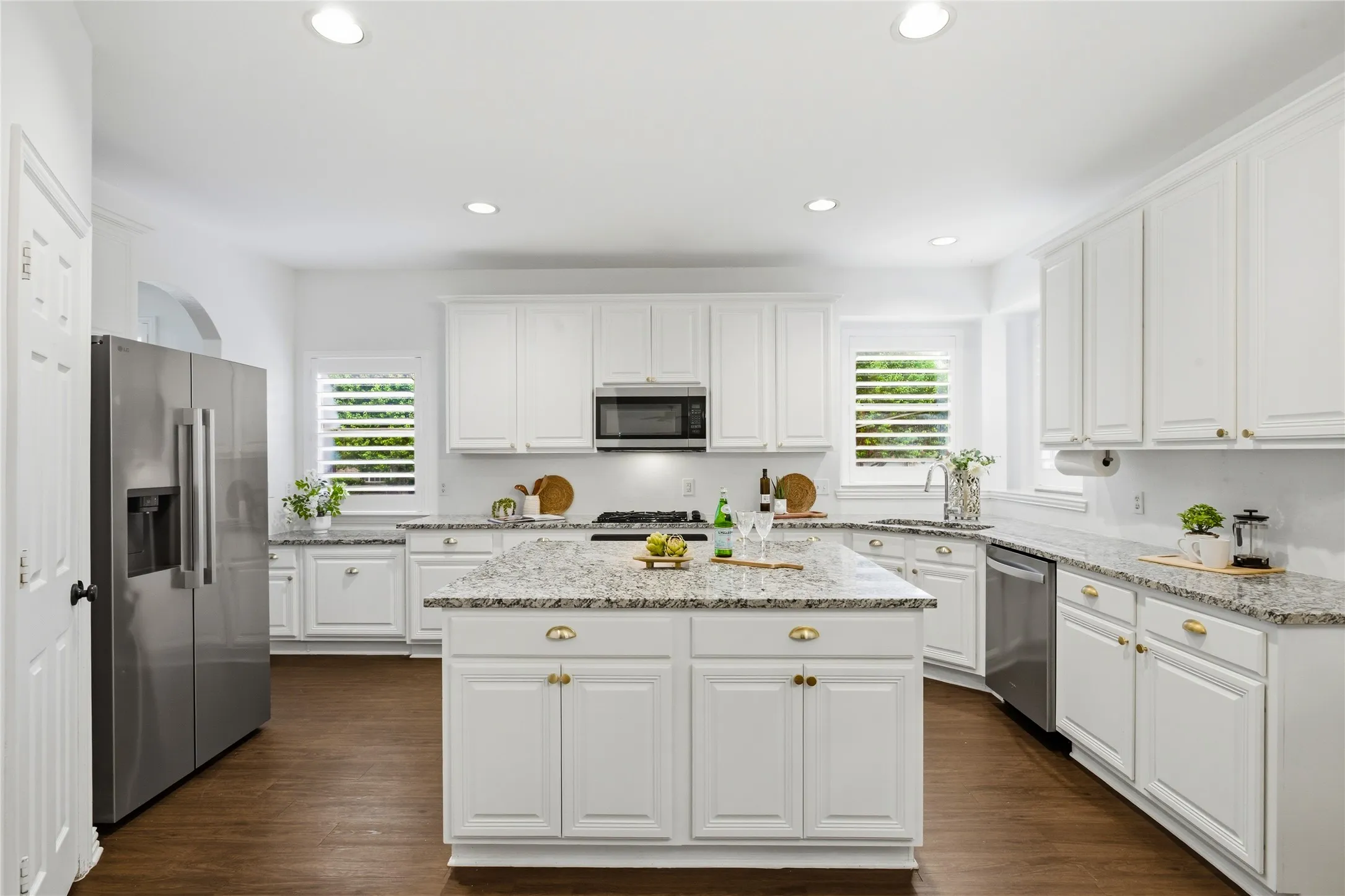 Giant island for entertaining or food prep. This kitchen has tons of cabinets for storage and walk in pantry. The stainless steel refrigerator conveys with home.