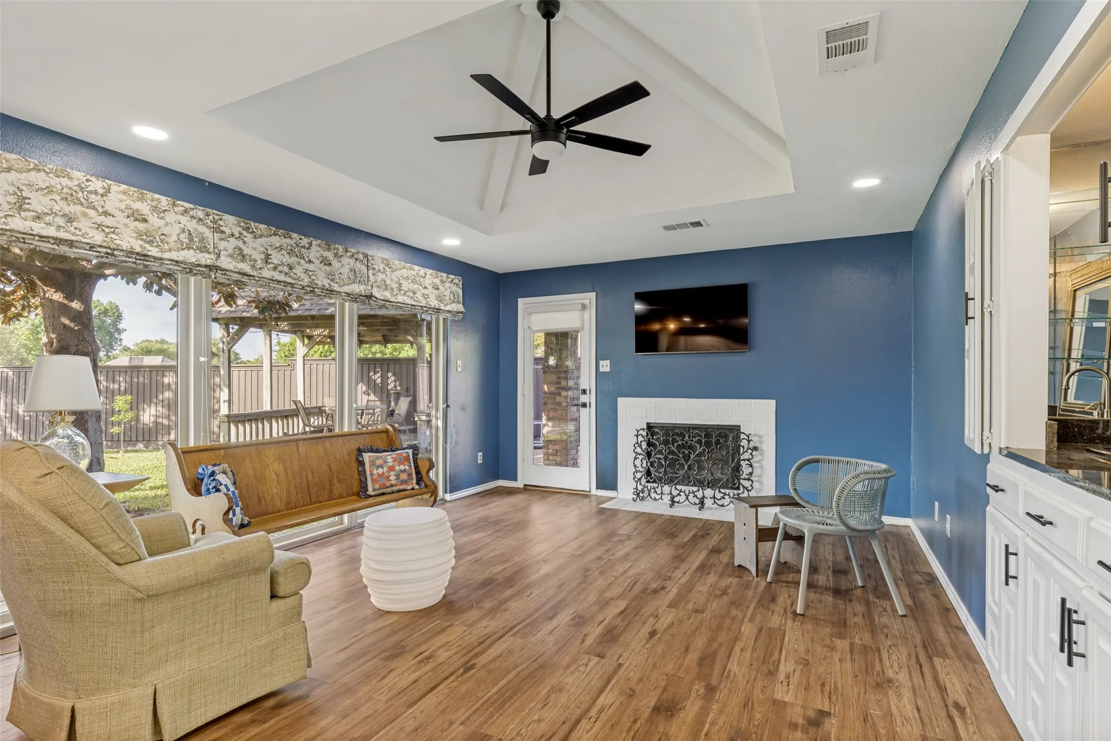 Second Living Area or Den with wood burning fireplace with gas starter and a wet-bar
