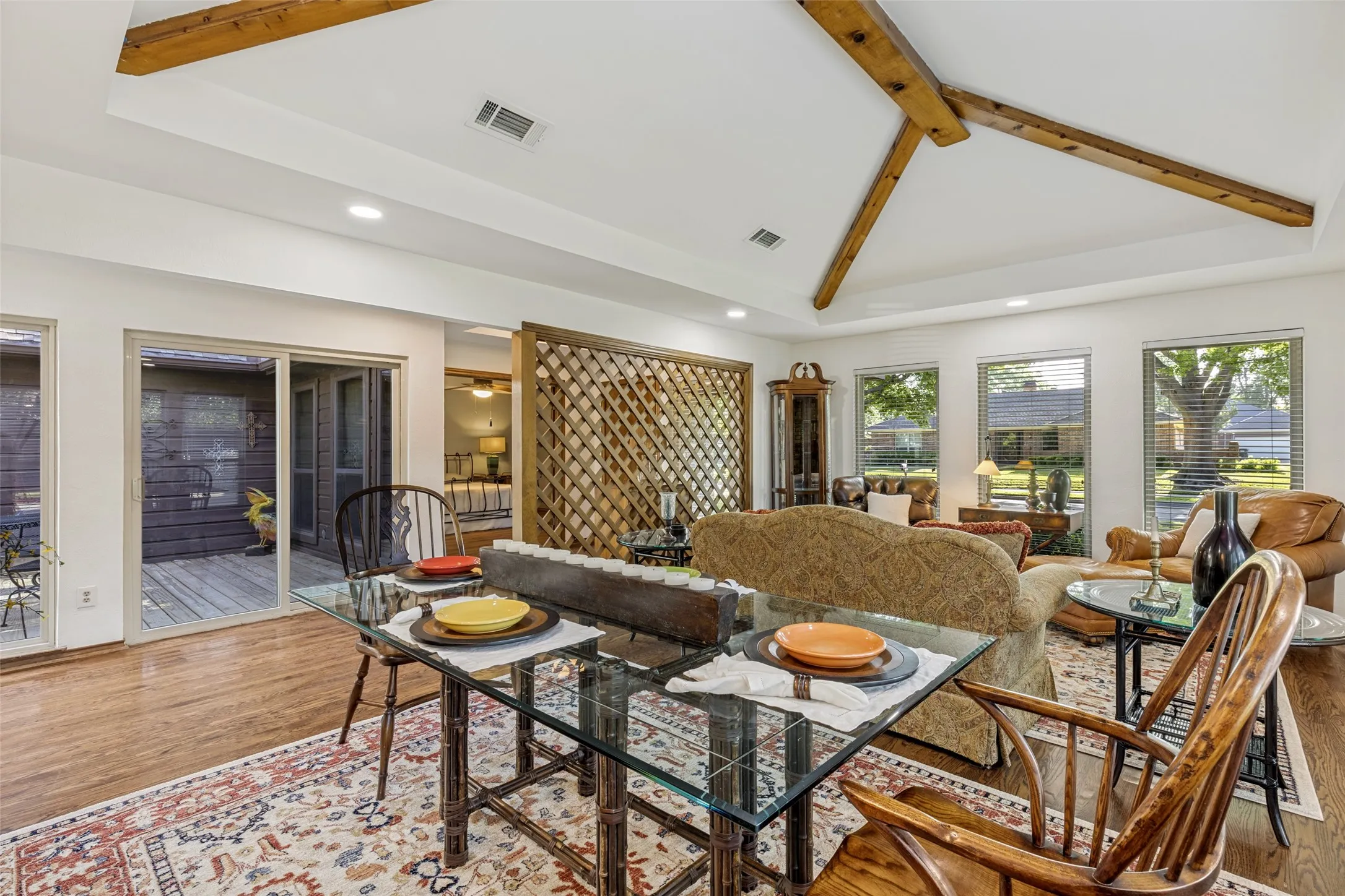 Formal Living Room features hard wood flooring, fireplace and vaulted ceiling