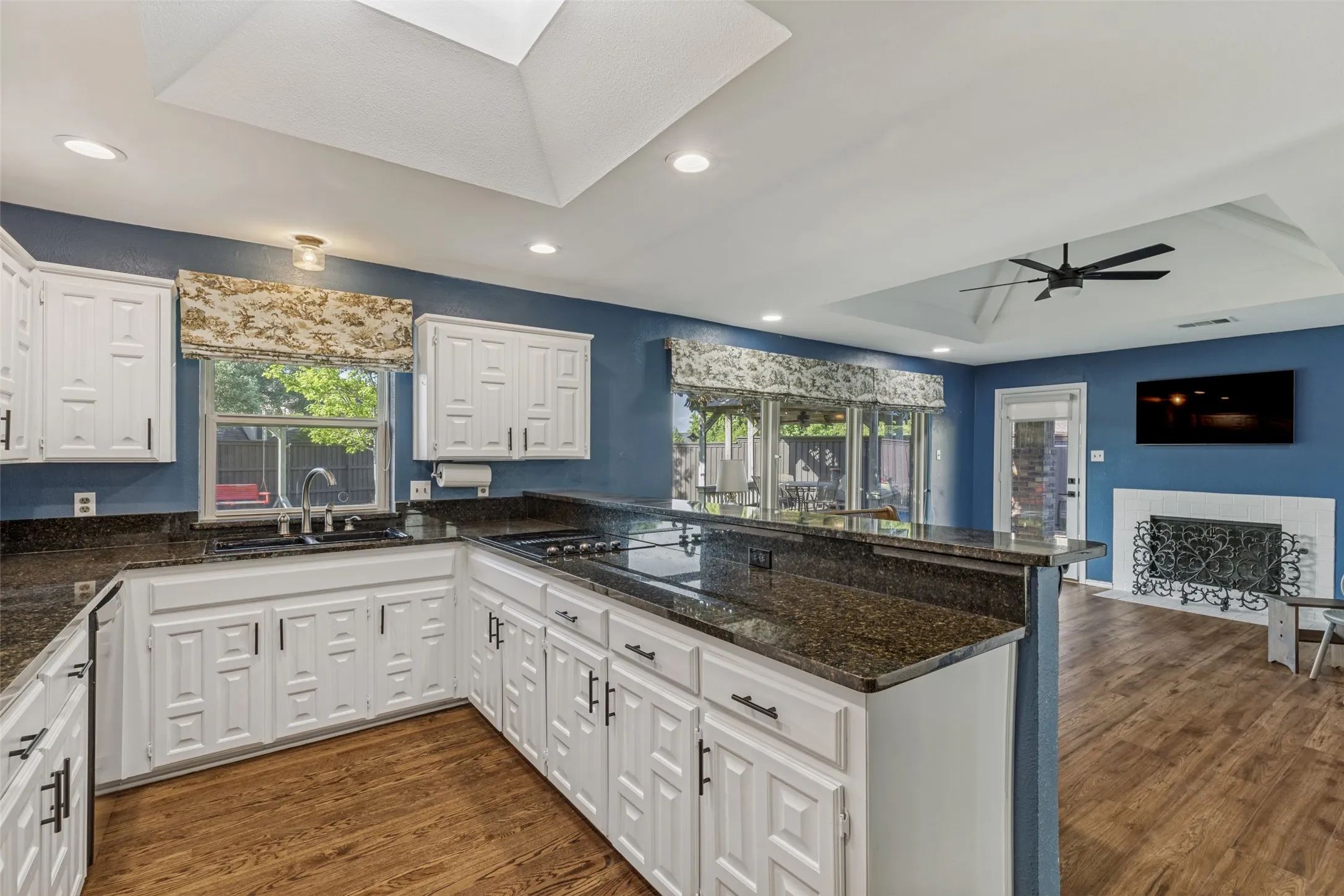 Kitchen with granite counter tops and skylight which allow additional natural light into the kitchen