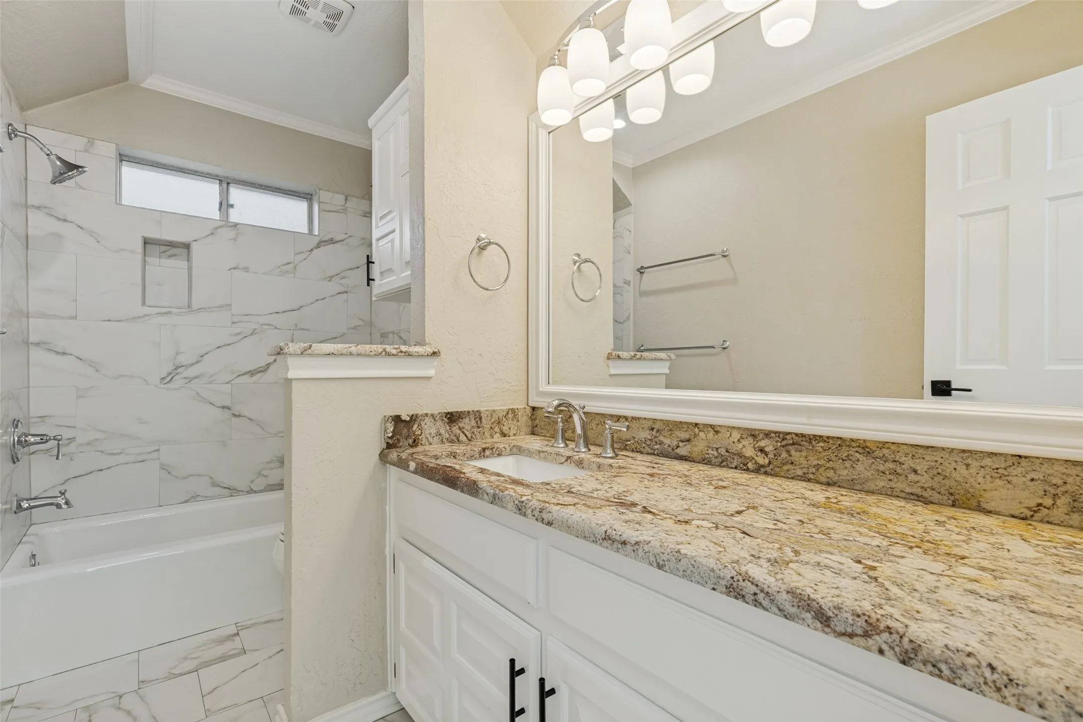Hall Bathroom or Guest Bathroom features granite counter tops and tub / shower.