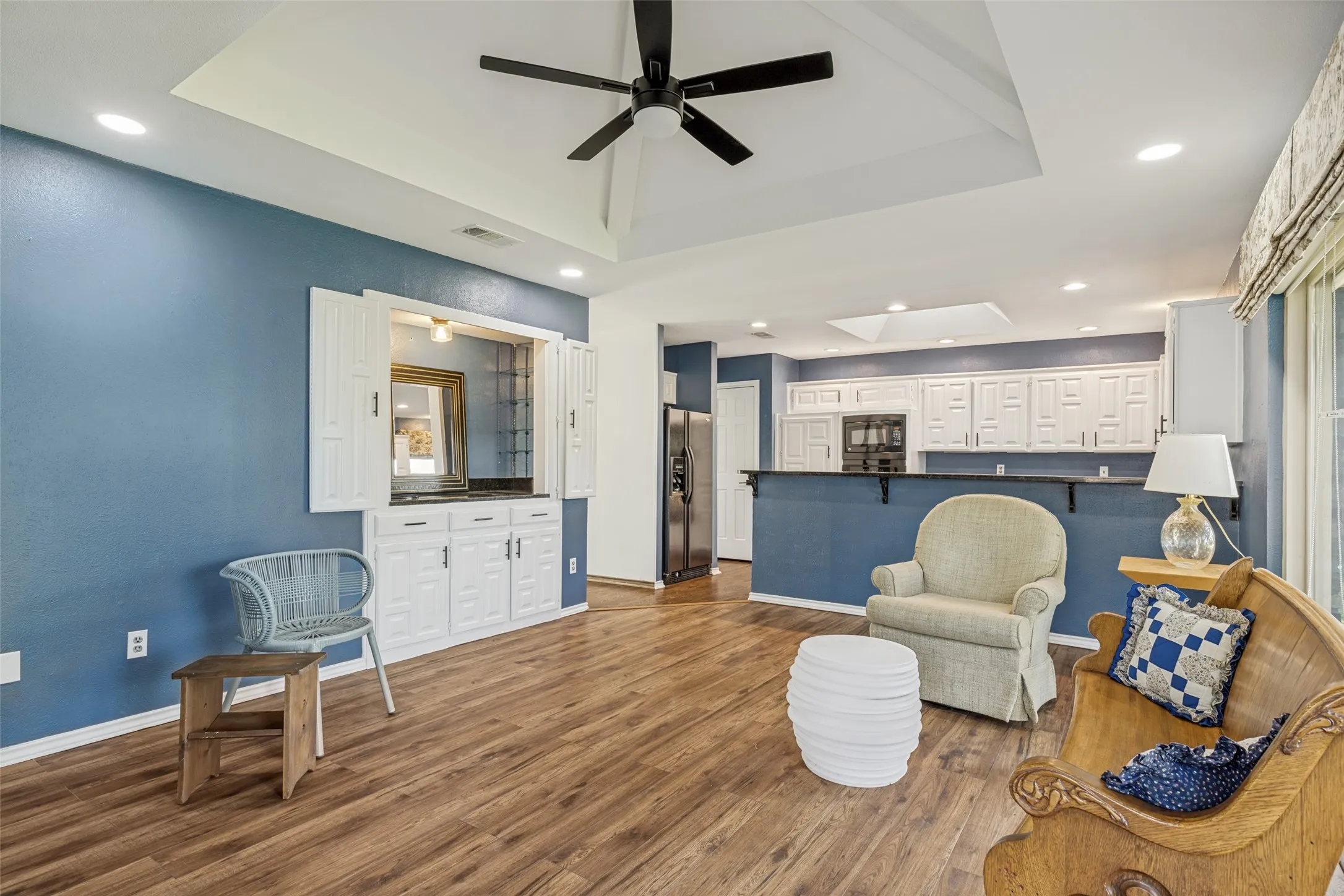 Den with ceiling fan and open to the remodeled kitchen