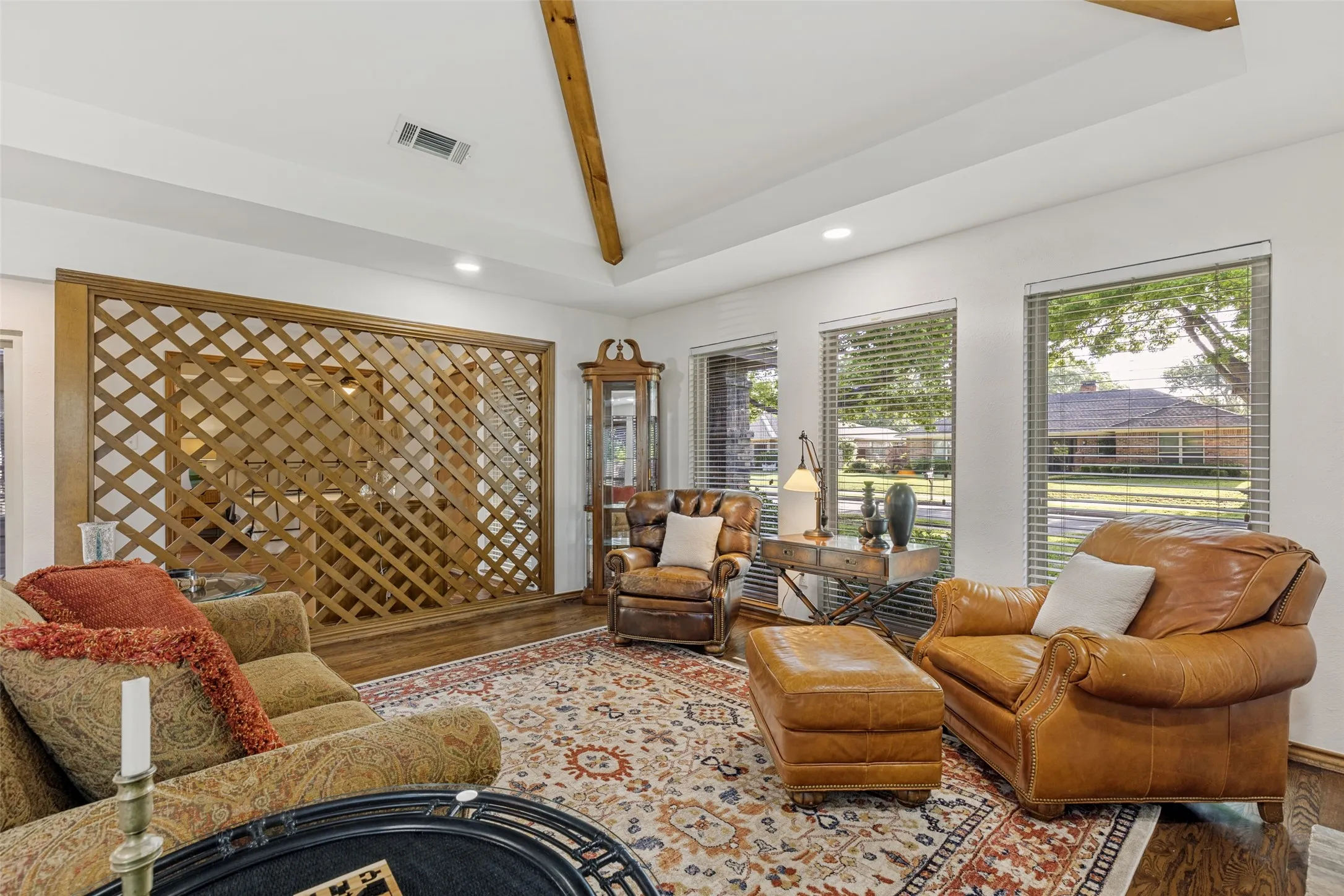Another view of the Formal Living Room with large windows overlooking the front lawn