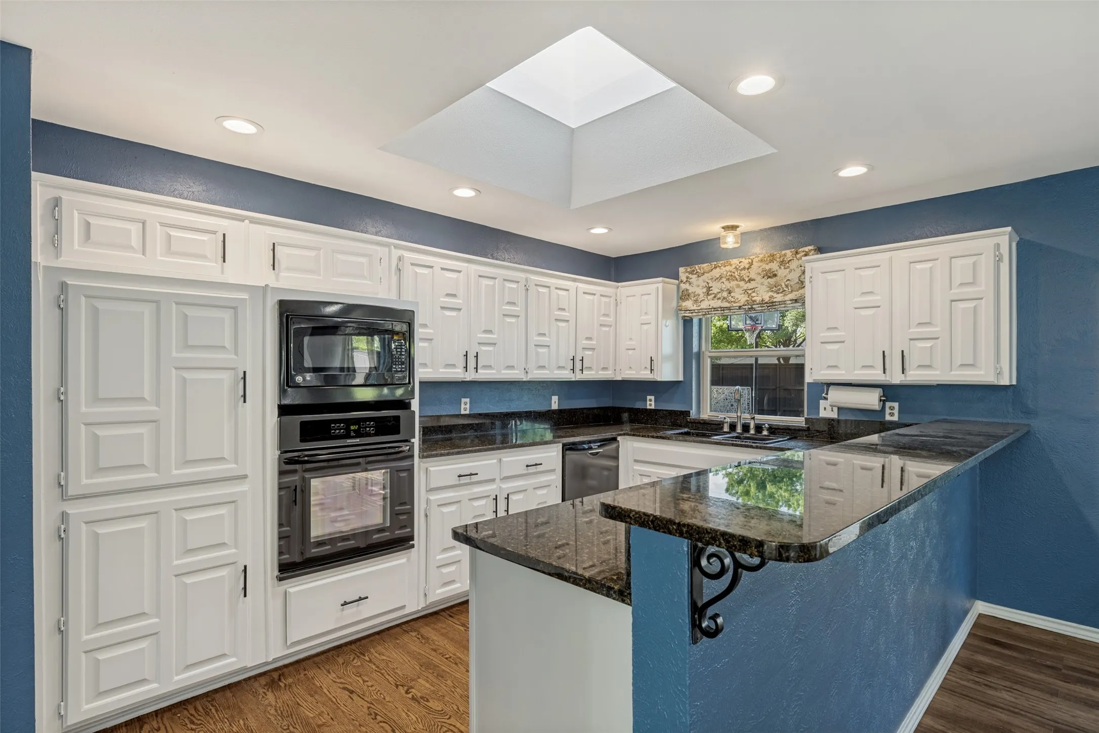 Nice view of the kitchen showing all the built-in cabinetry for storage and built-in oven and microwave