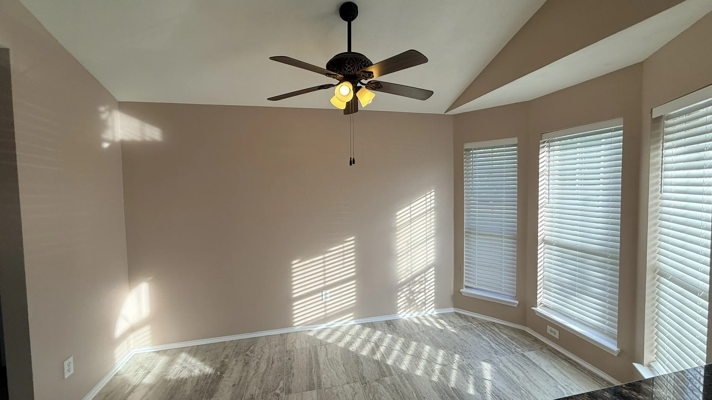 Unfurnished room with lofted ceiling and ceiling fan