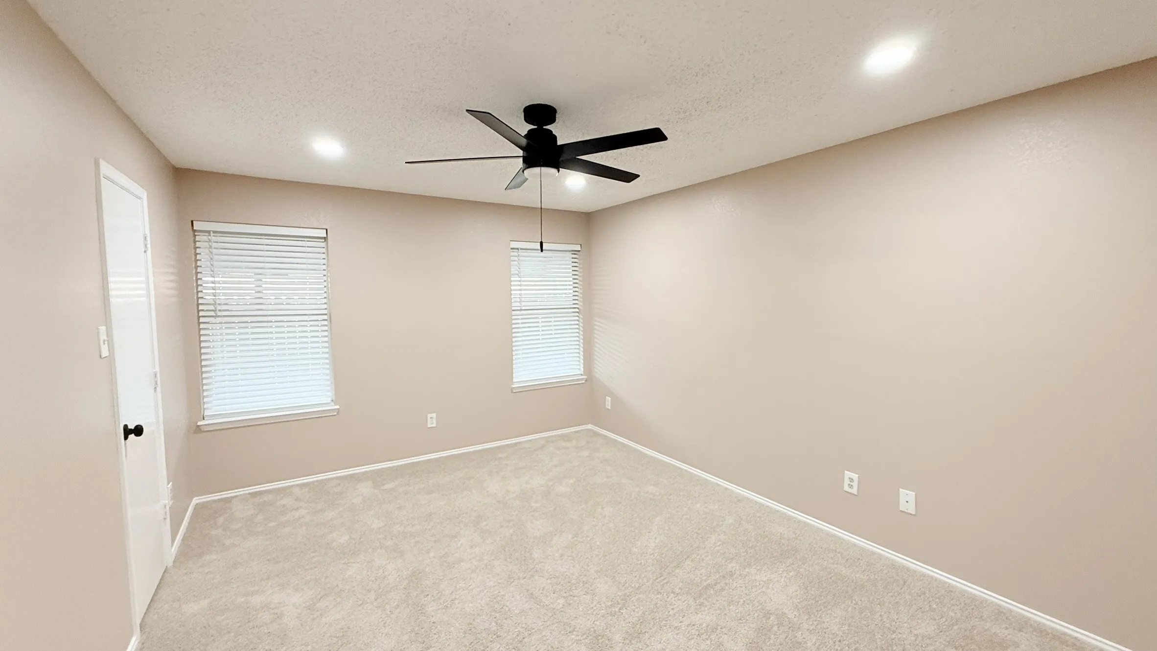 Empty room with a ceiling fan, a textured ceiling, light carpet, and recessed lighting